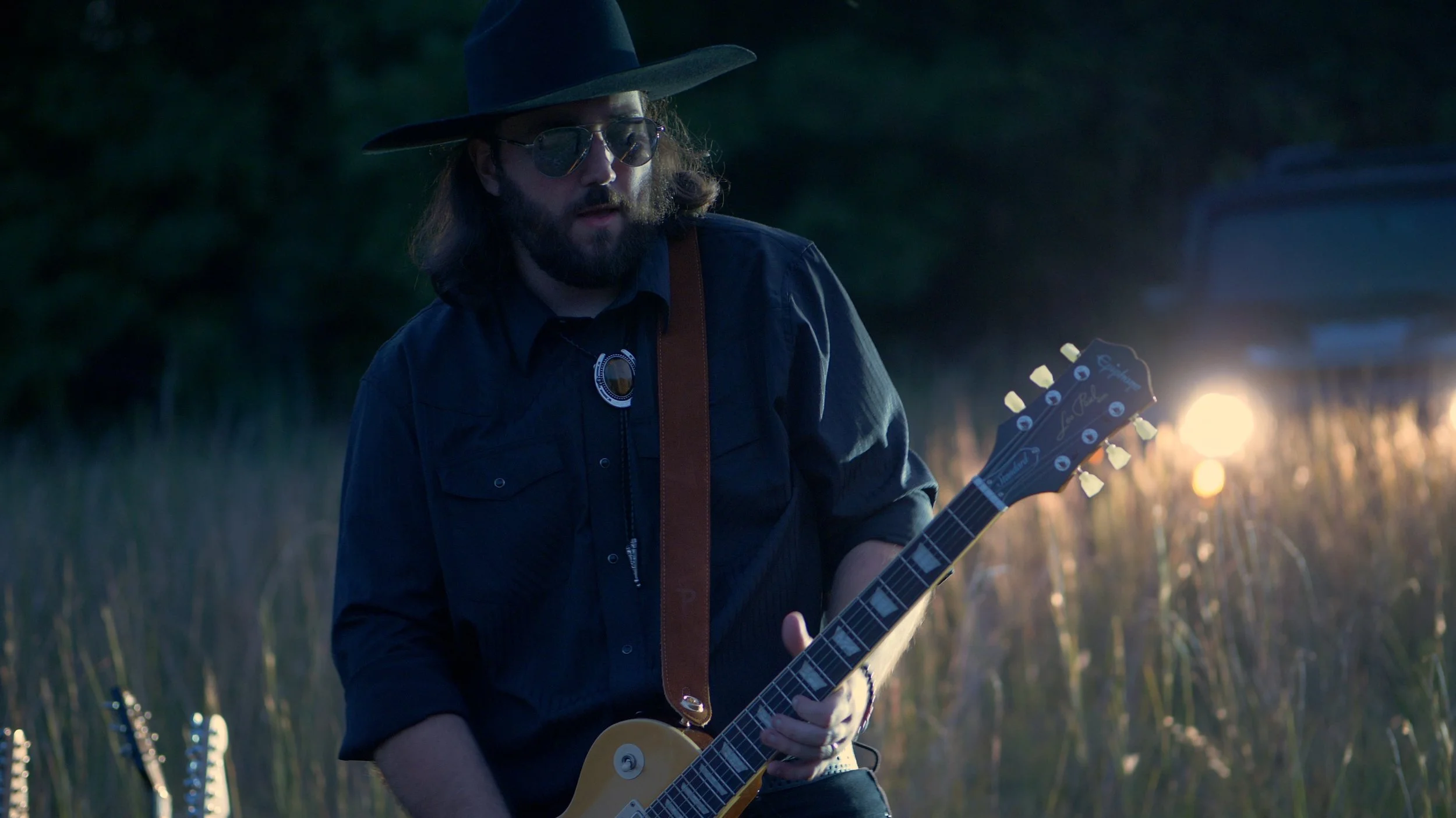 Nic Ziter playing guitar during the blue hour performance scenes for Delta Circle’s My Own Doctor music video.