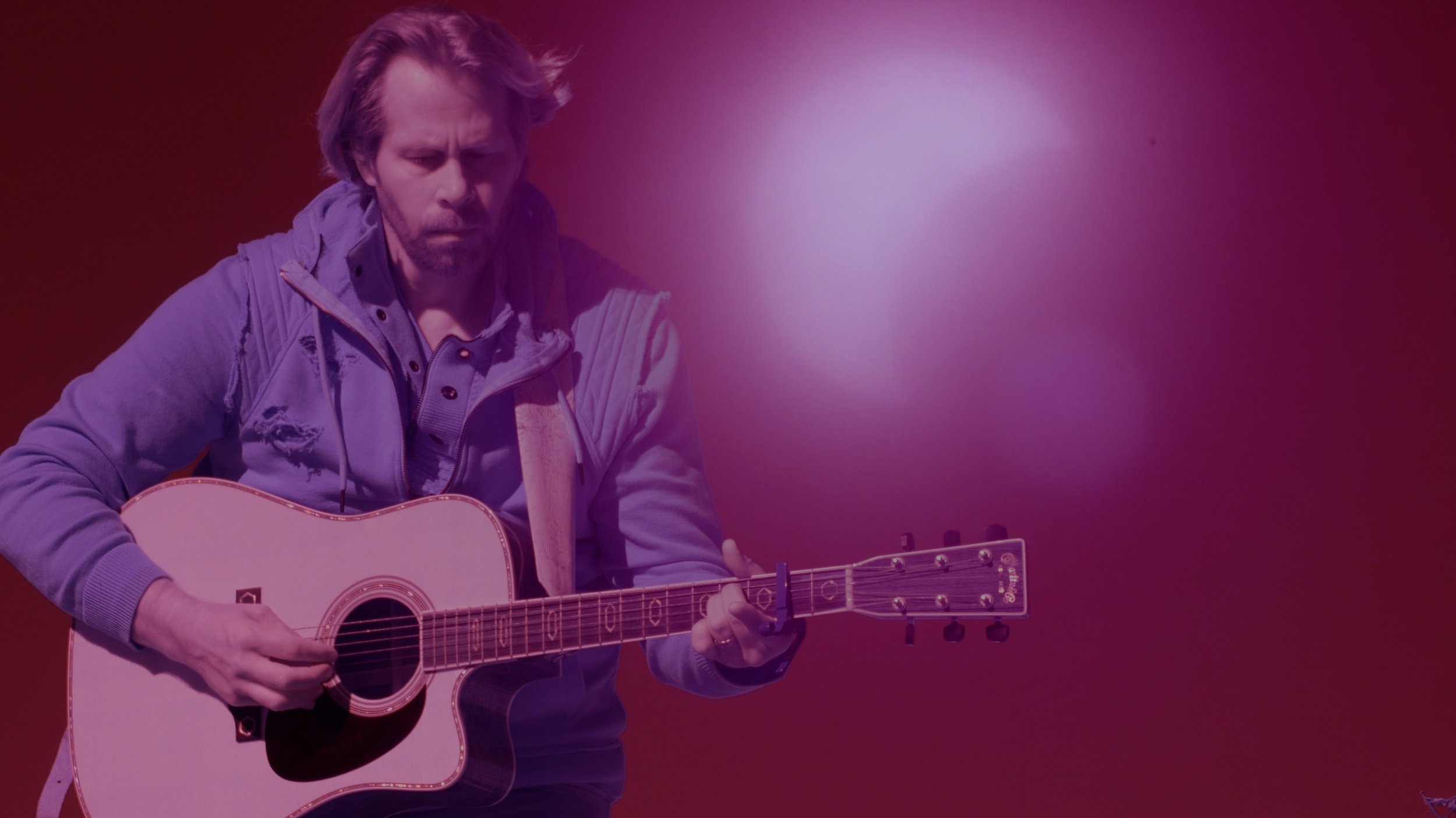 Charles Maring performing on guitar during an eclipse in color infrared