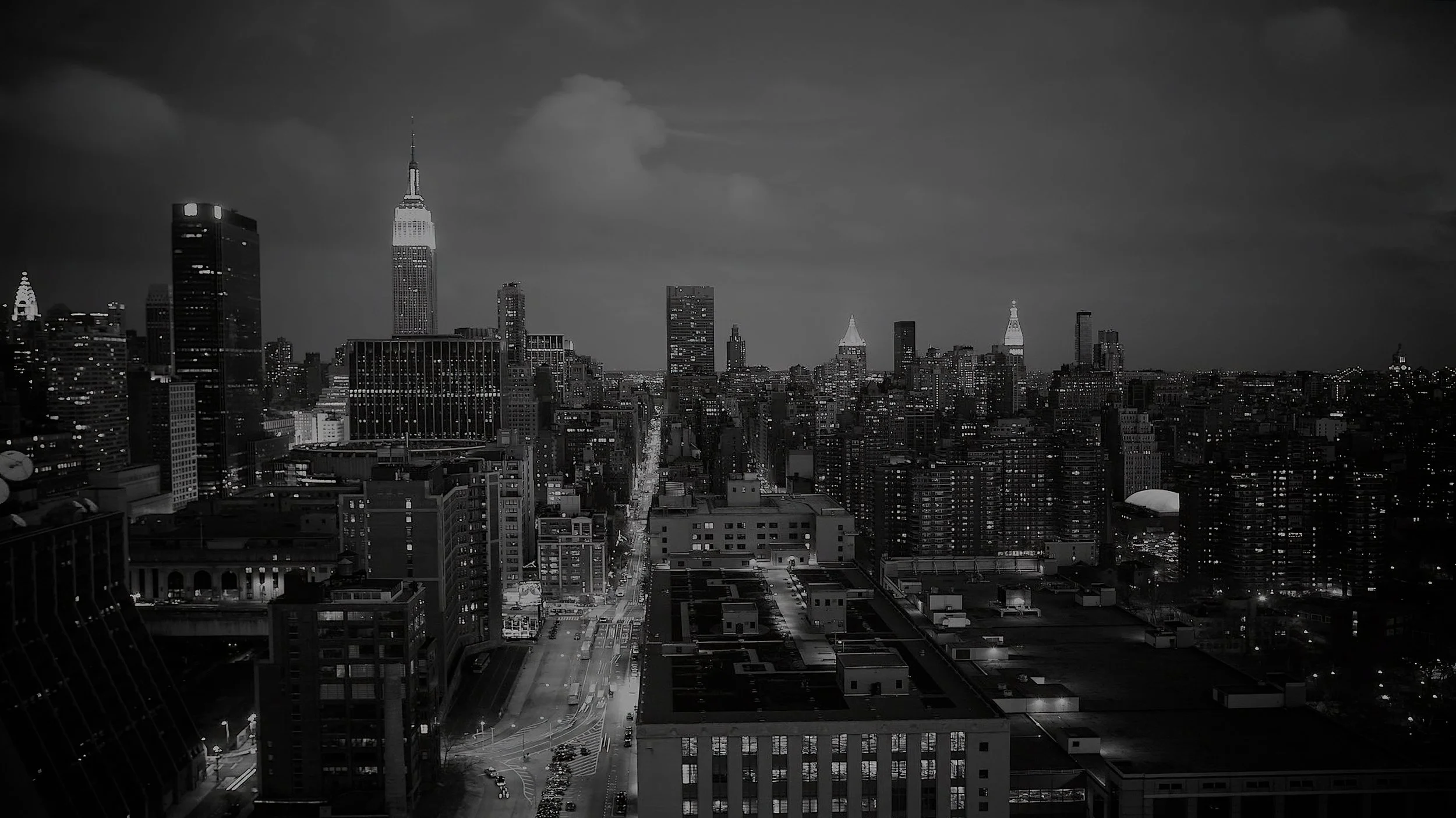 Black and white Manhattan skyline at night photographed during a New York City wedding weekend.