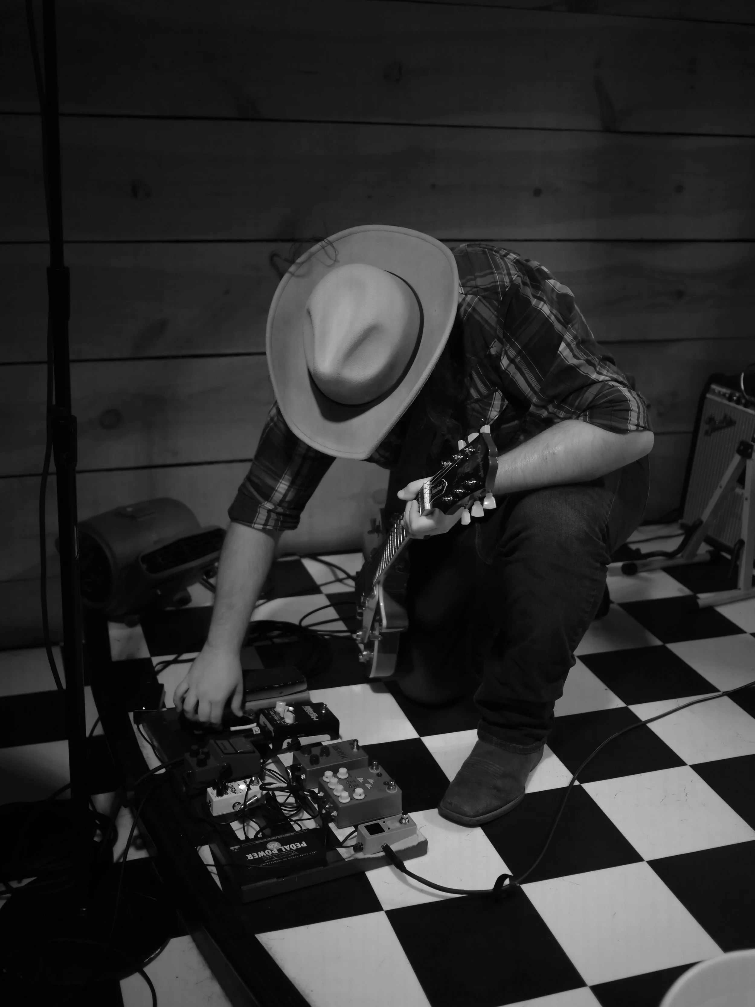 Delta Circle guitarist adjusts effects pedals before performing at Honky Tonk South in Savannah.