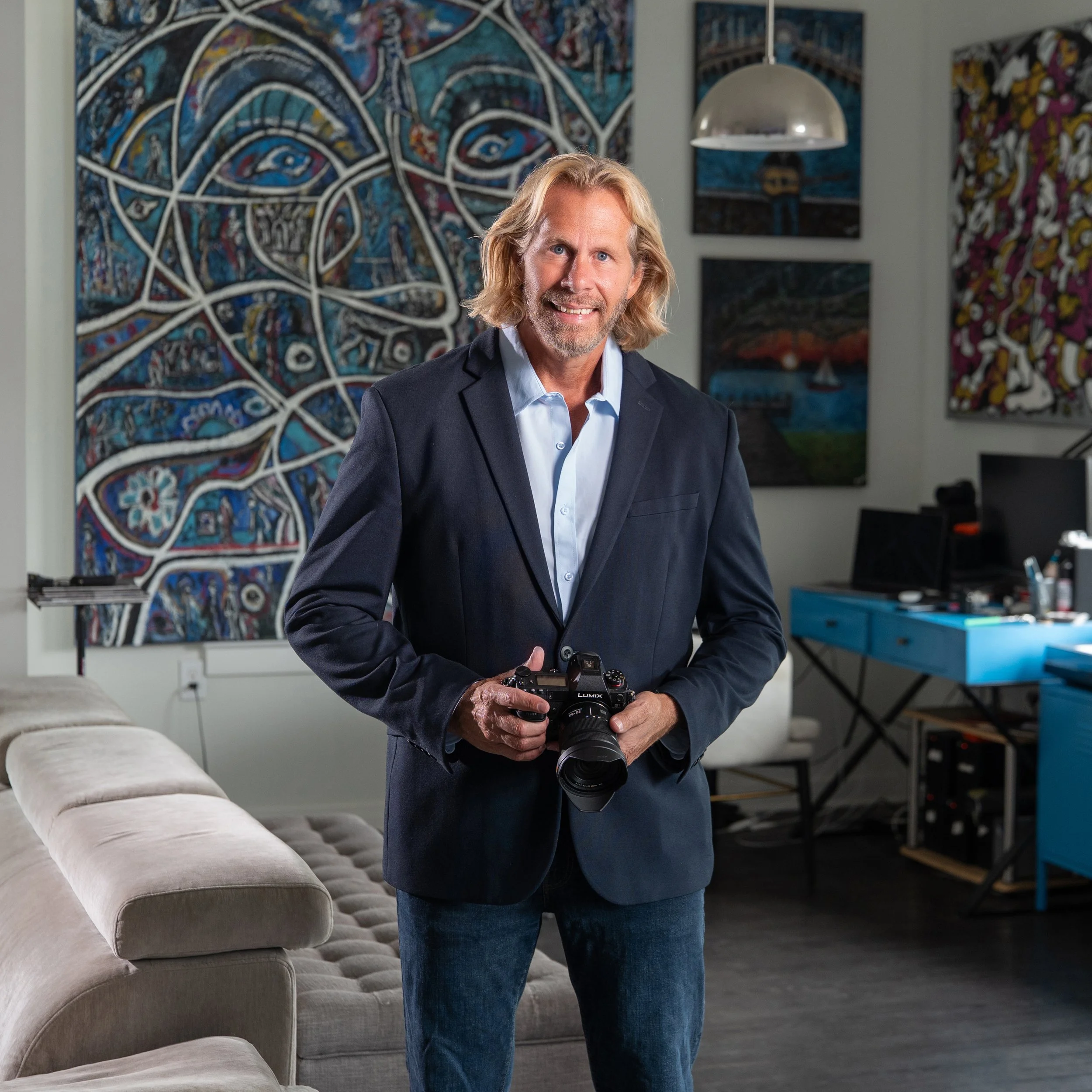 Charles Maring in his Savannah art loft surrounded by original paintings