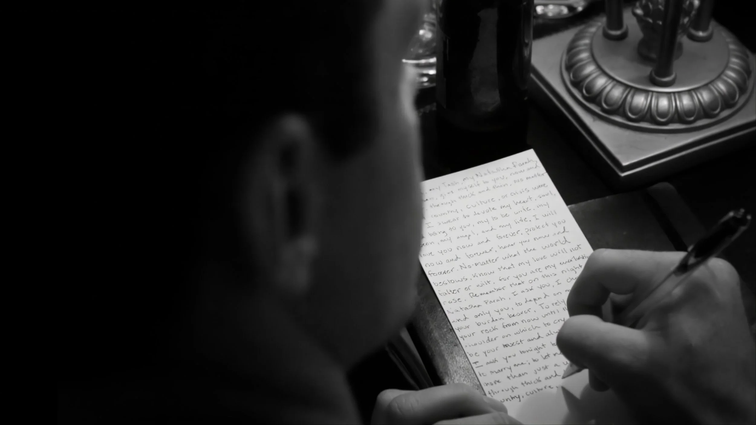 Groom writing a handwritten letter before his wedding at The Plaza Hotel in New York.