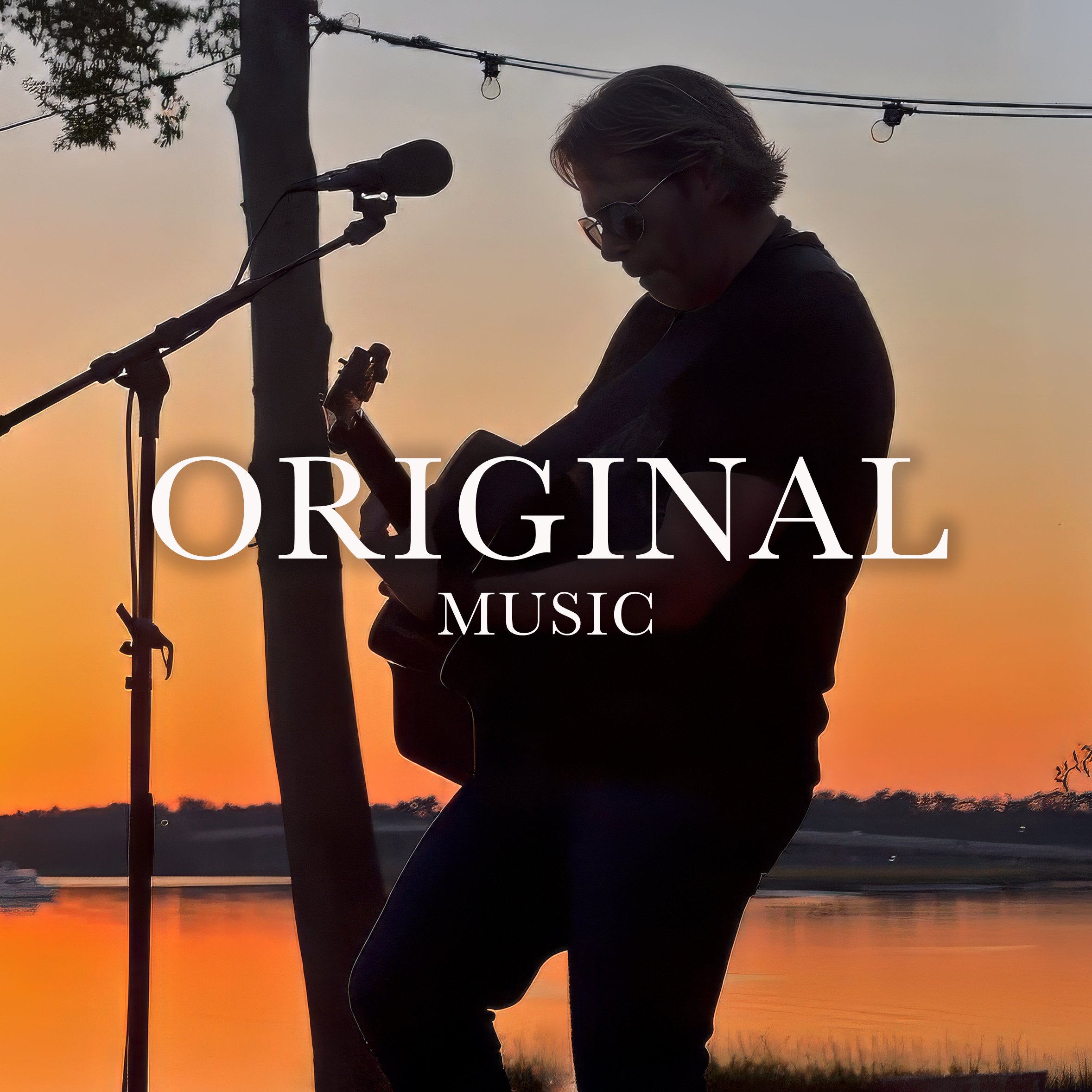 Charles Maring playing guitar in silhouette during a sunset performance while creating original music
