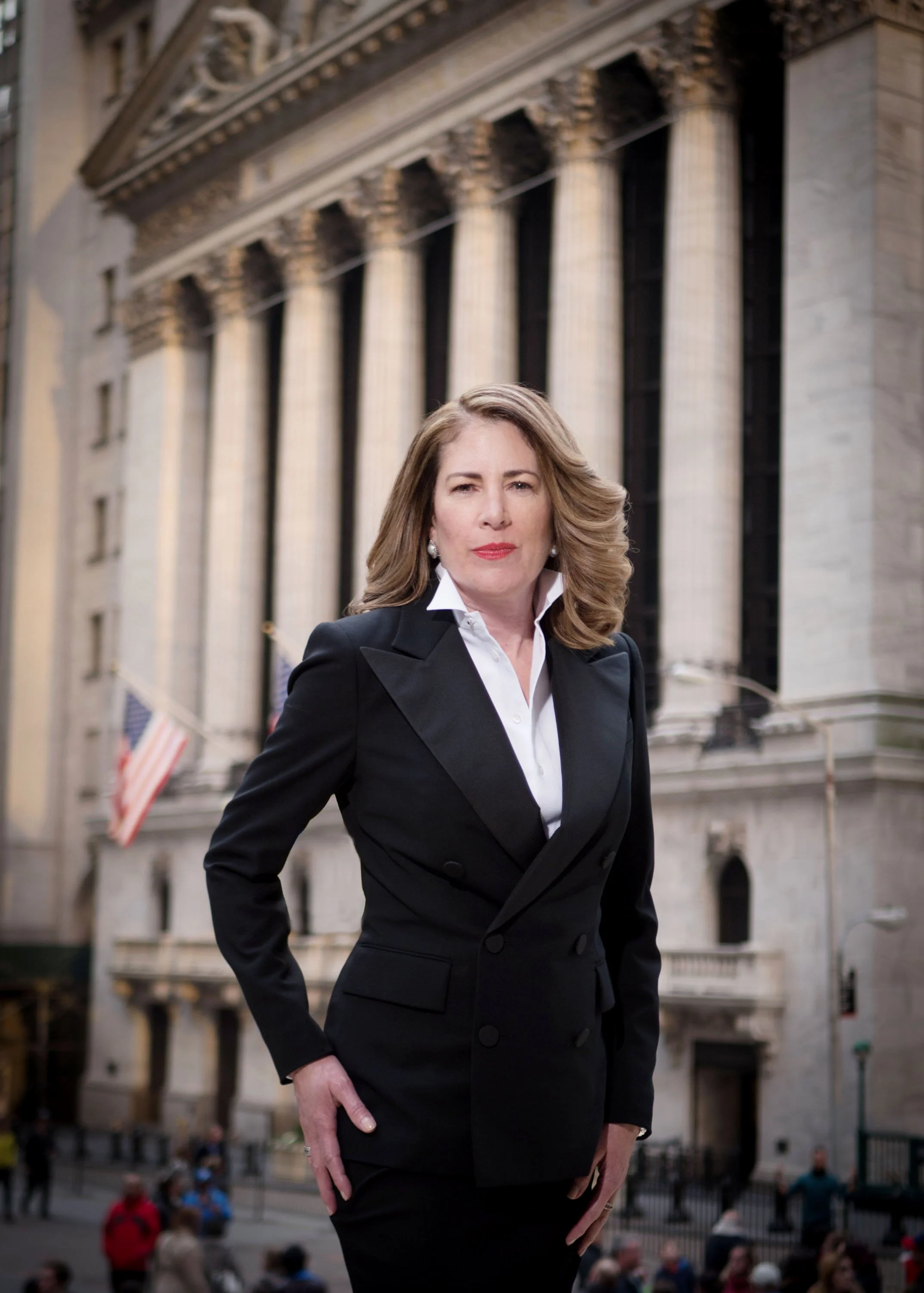 Environmental portrait of a female executive photographed by Charles Maring outside the New York Stock Exchange on Wall Street.