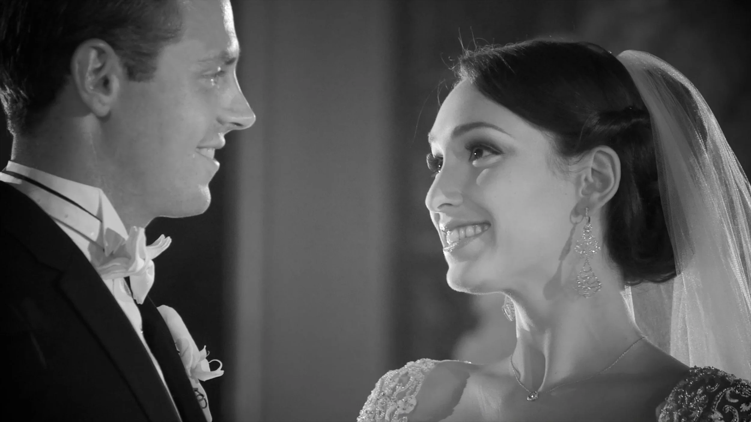 Bride and groom look at one another during their black and white wedding at The Plaza Hotel in New York.