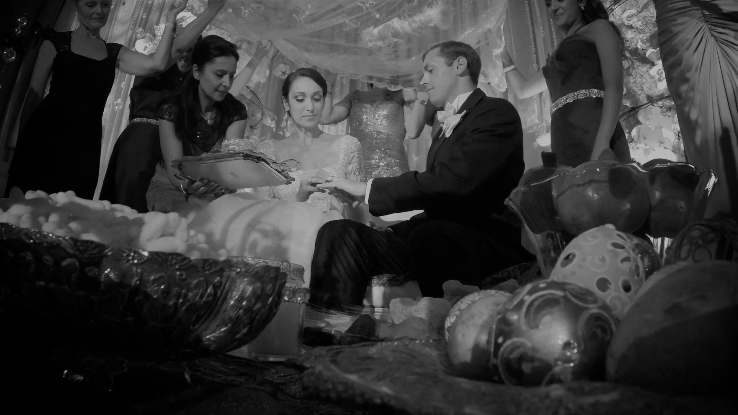 Bride and groom exchanging rings during their wedding ceremony at The Plaza Hotel.