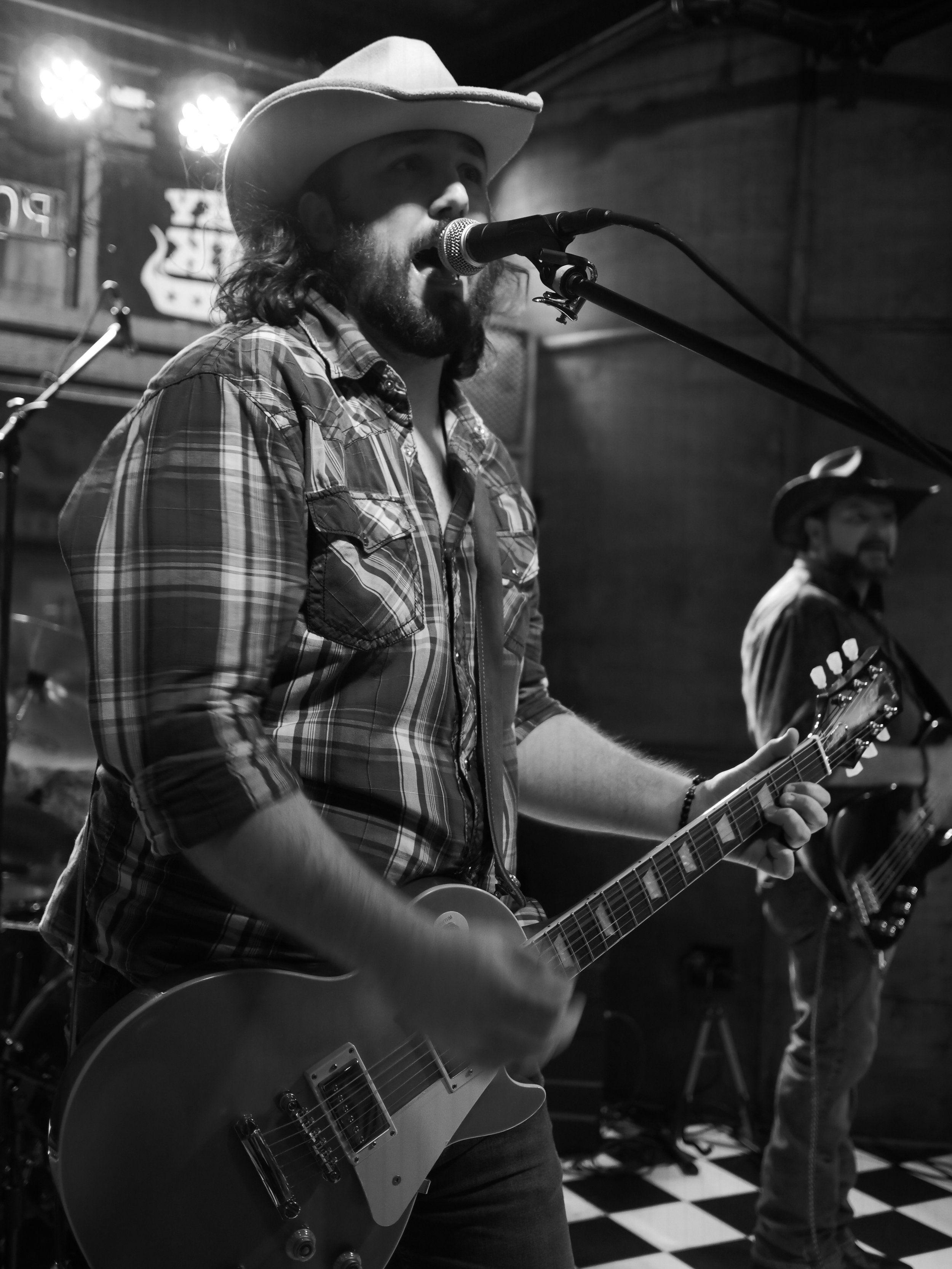 Delta Circle vocalist Nic Ziter singing and playing guitar at Honky Tonk South in Savannah.