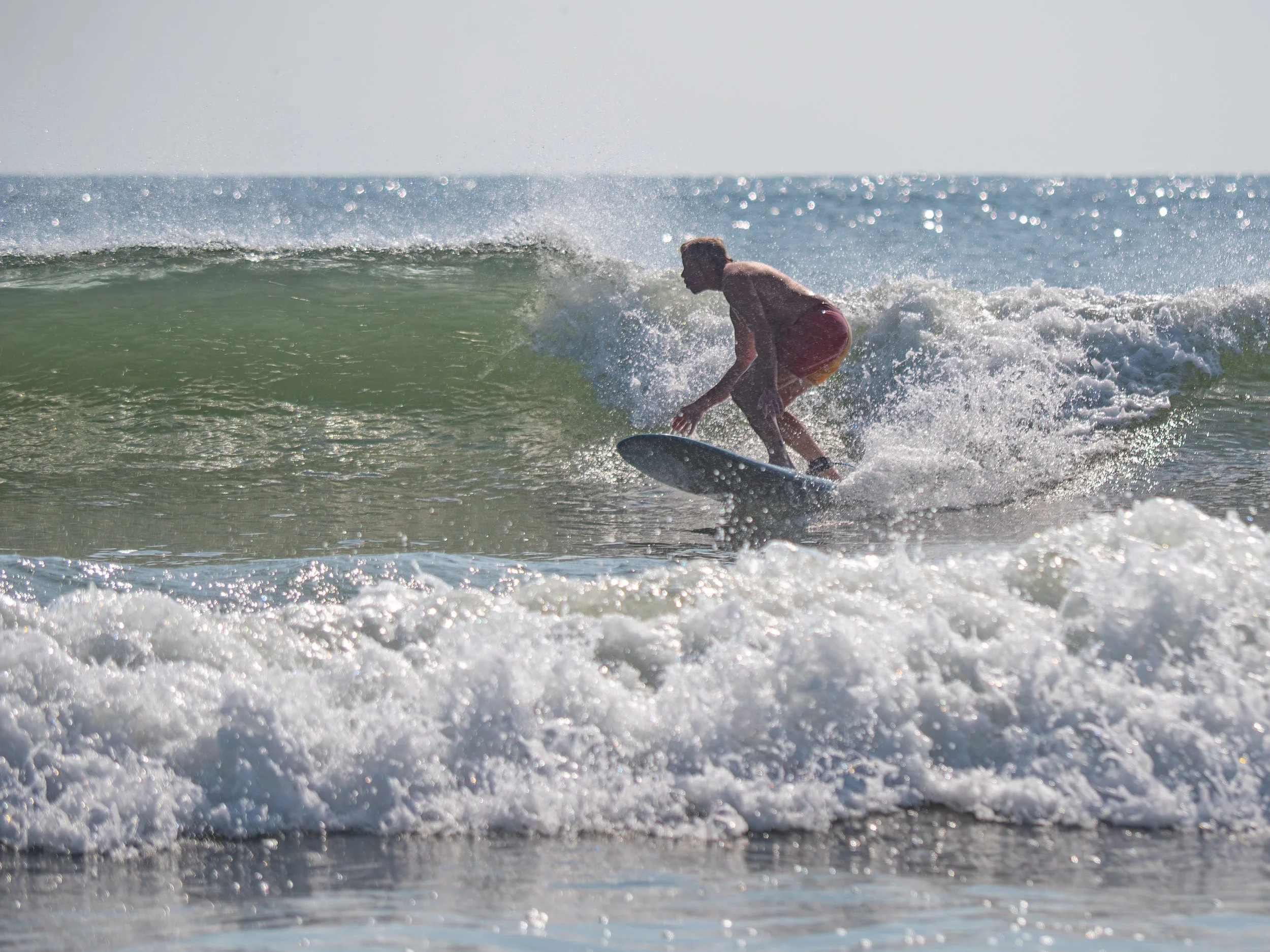 Charles Maring surfing on a wave