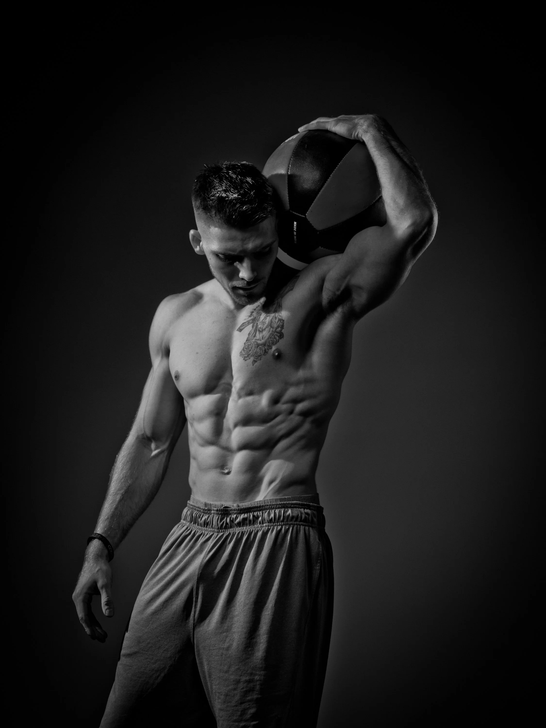 A black and white athletic portrait built around strength, form, gesture and carefully controlled studio light.