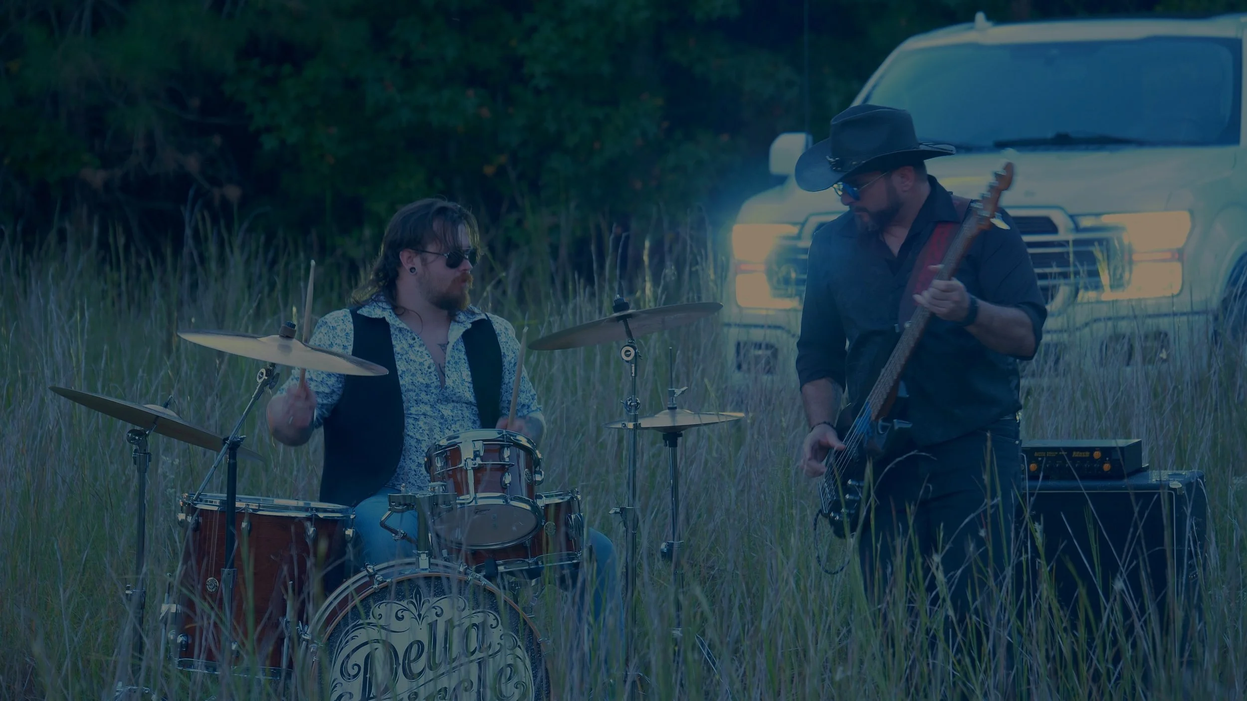 Darrell Anthony on drums and Earnest Spiva on bass performing with Delta Circle at dusk outside Savannah.