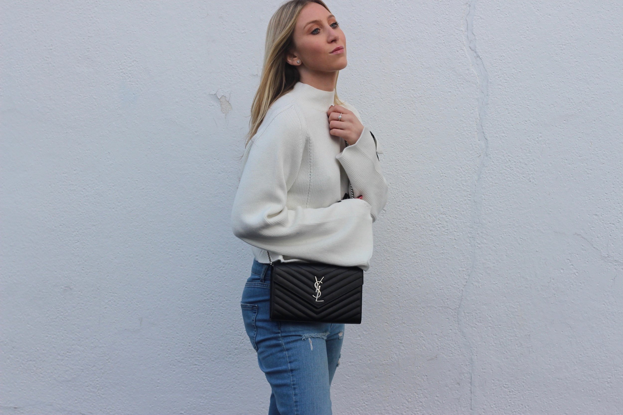 Ysl cross body bag and statement sweater by Au Courant Life