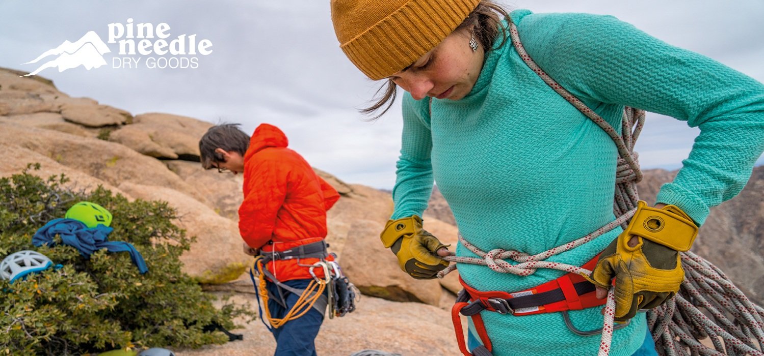 People putting on climbing gear