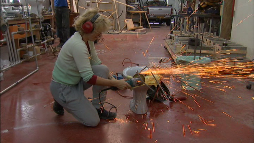 A still of artist Sigalit Landau welding in the film Out in the World