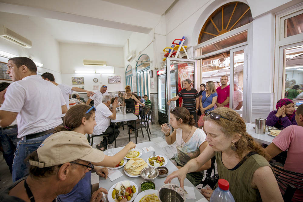 Happy customers at the Sa’id hummus shop, Akko. Photo by and © Vision Studio 