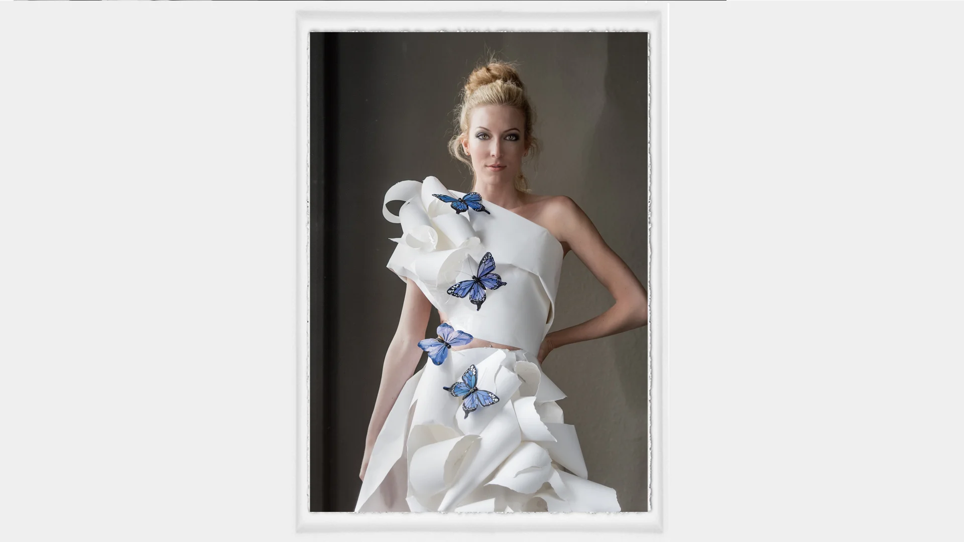 Here is a fun photo shoot idea. Why not make a garment for your subject to wear out of paper. Yes Paper! Why? two reasons. First, it is just fun, and is a terrific experience for the model. Two, it is an inexpensive way to capture images that are out of the "normal" box. In the image above, I just wrapped paper around the subject's upper body first, and then tore bit's of paper and taped the torn pieces onto the paper background. I have the model wear a simple slip for comfort, so I don't have to tape to her body. 
