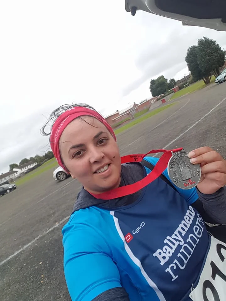 Parveen Akhtar displays her Lough View 10k medal