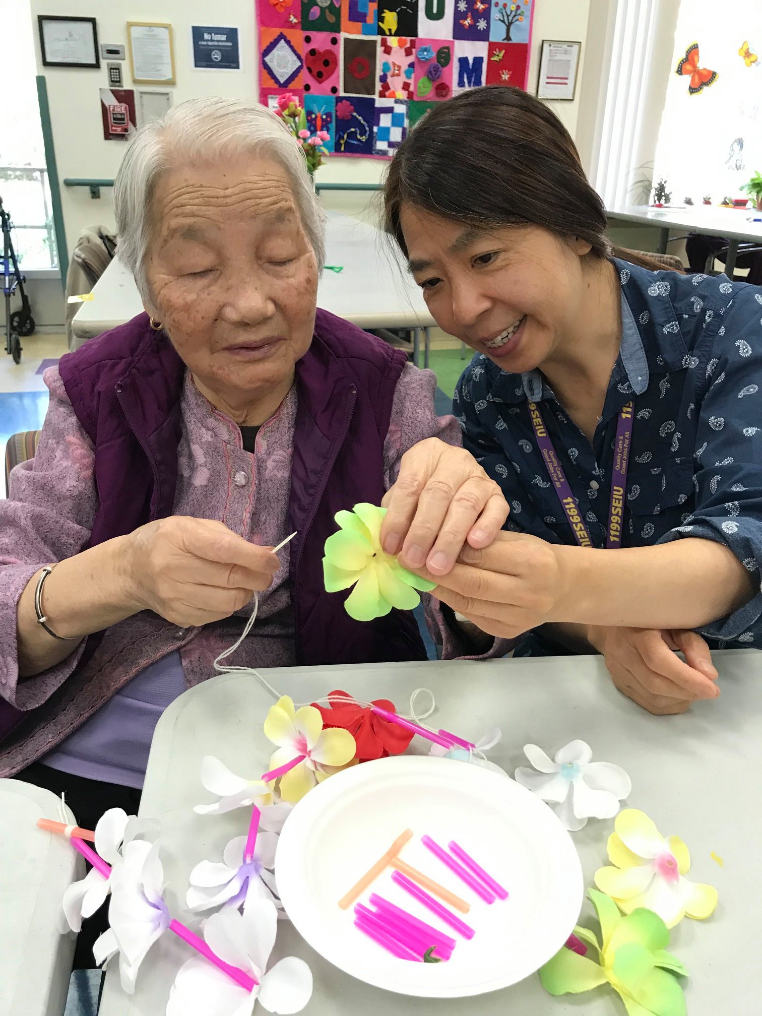 staff member making craft with participant