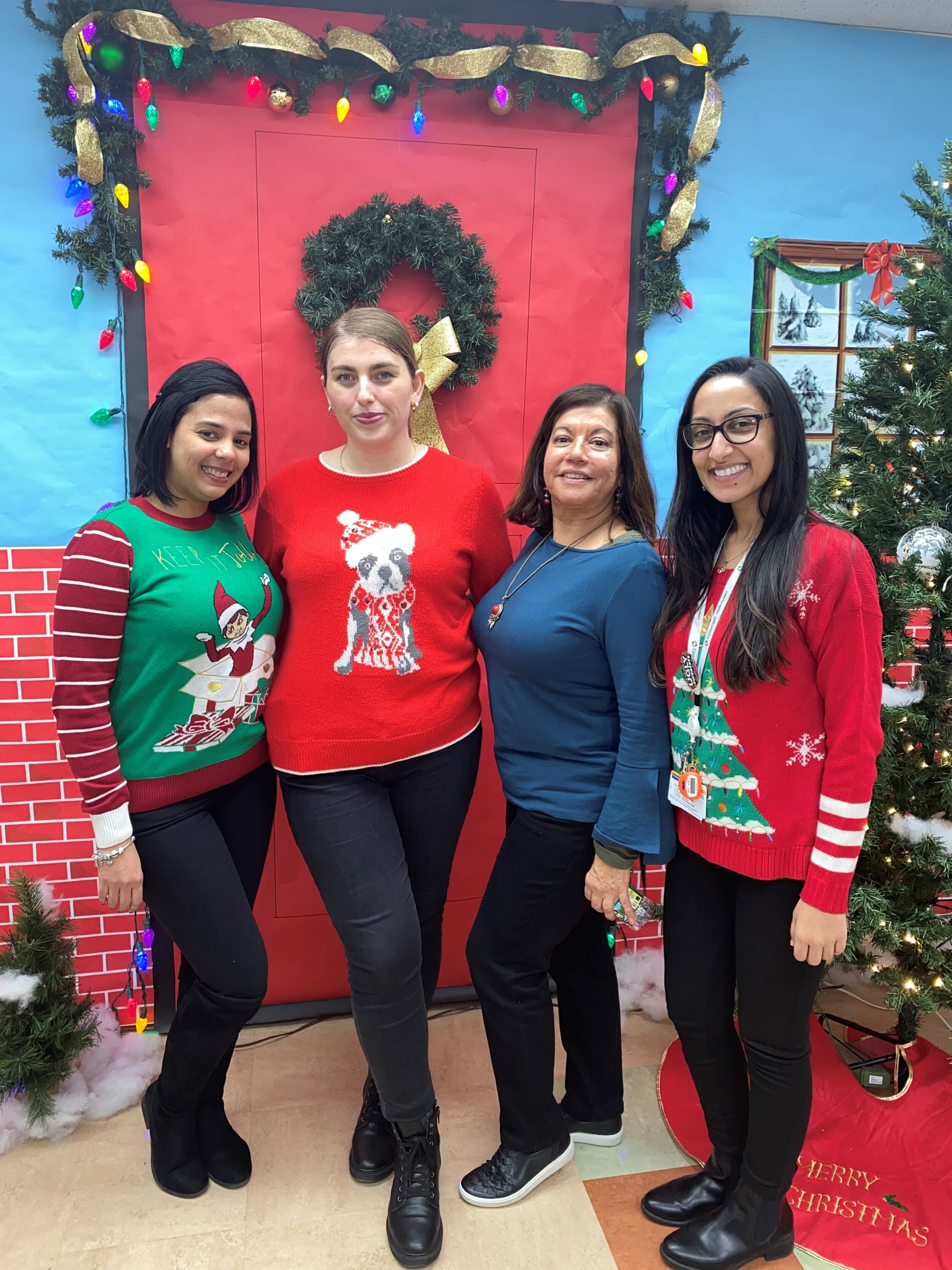 Teamcare staff wearing their ugly Christmas sweaters