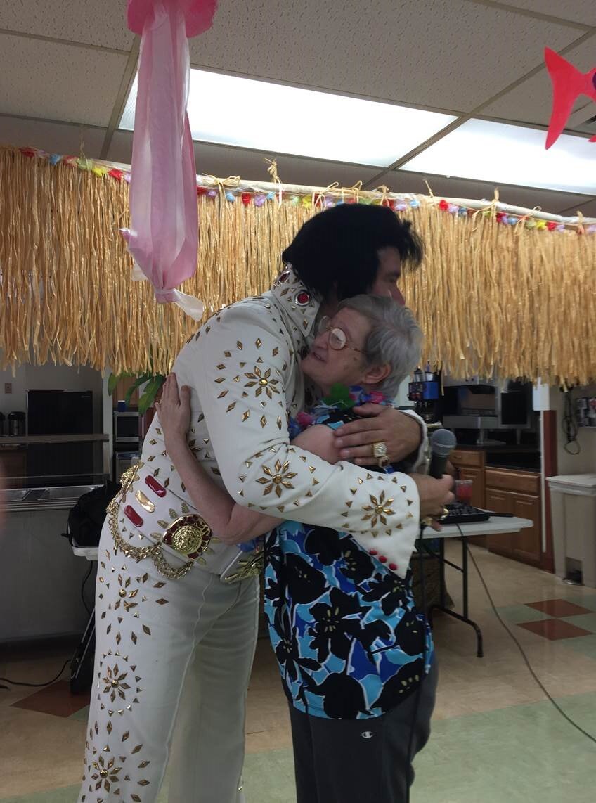Elvis impersonator hugs participant