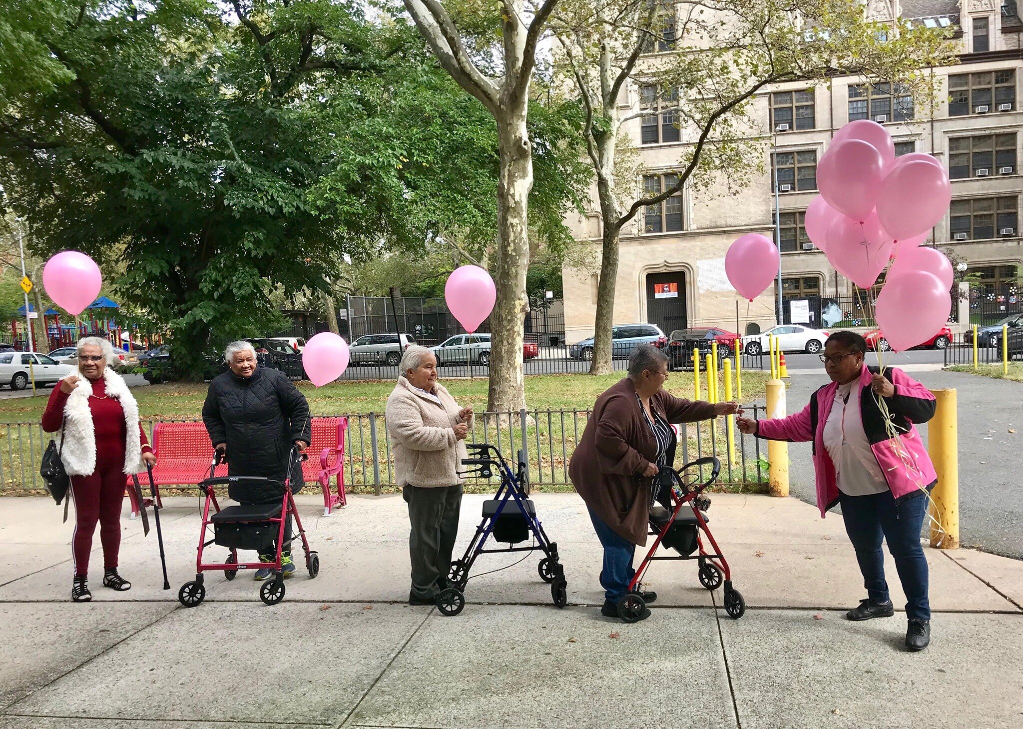 participants and staff release pink balloons