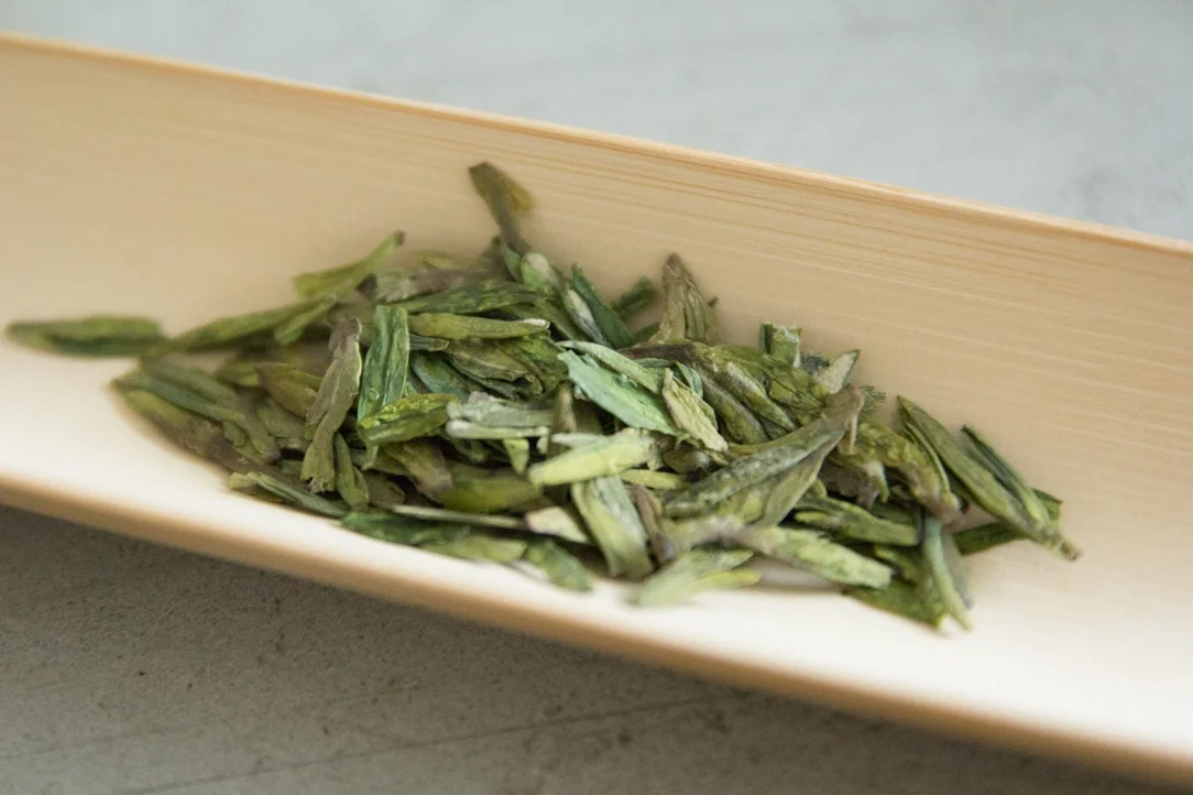 Beautiful long blades of Longjing (Dragon's Well) tea leaves – a varietal of green teas.