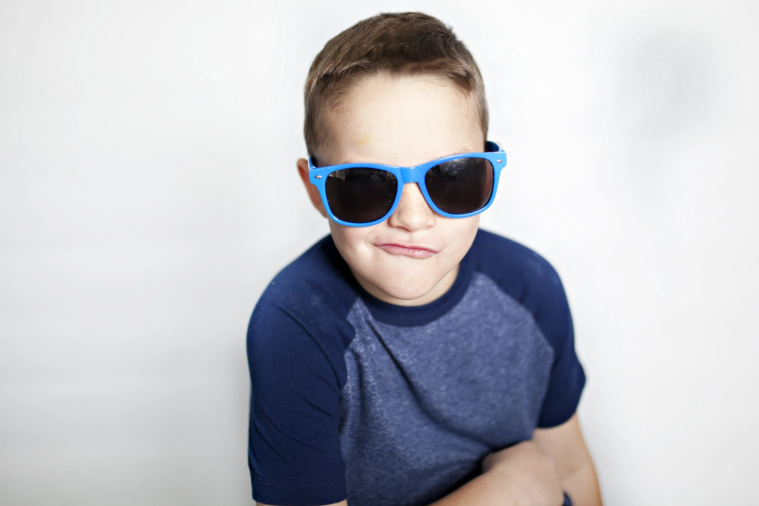 BOY_HH_portrait-of-boy-in-sunglasses-on-iphone-listening-to-music-and-dancing-in-headphones-against-a-white_t20_3JRV6o.jpg