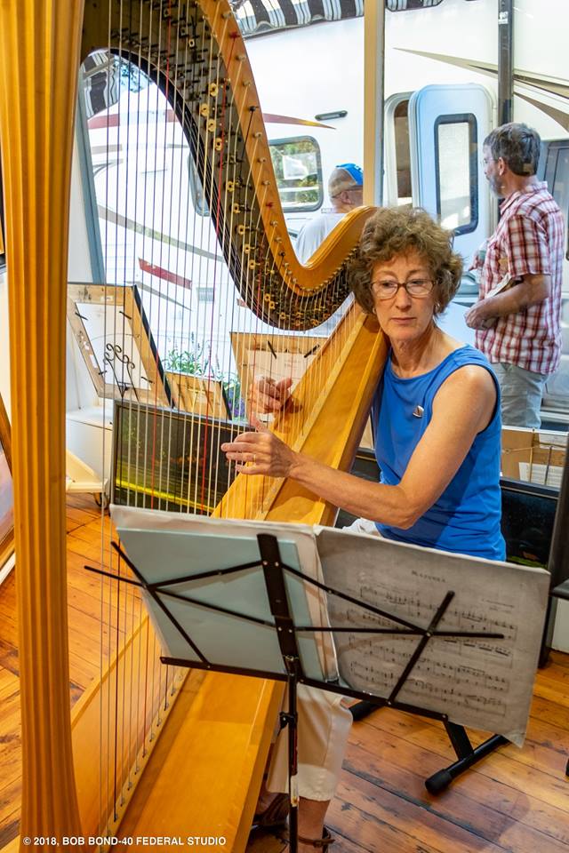 Suki Flanagan plays harp in Sylvan Gallery during the August 2018 Wiscasset Art Walk. (Bob Bond photo)