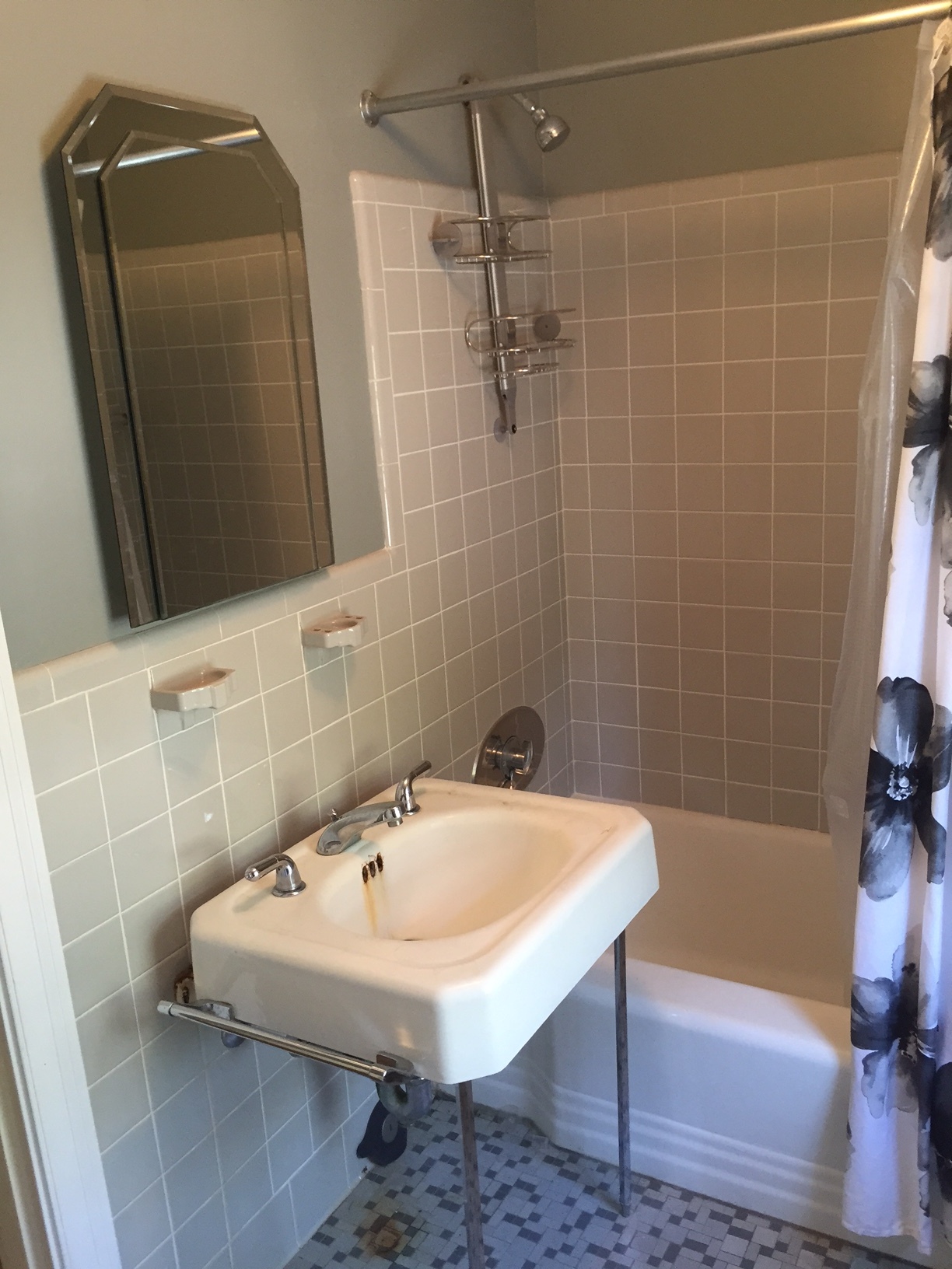 Original 1950's bathroom, including rust stain on the sink. I had to add my own personal touch with the Target shower curtain to even bear using this bathroom while waiting for our permits to demo... for 3 weeks. 