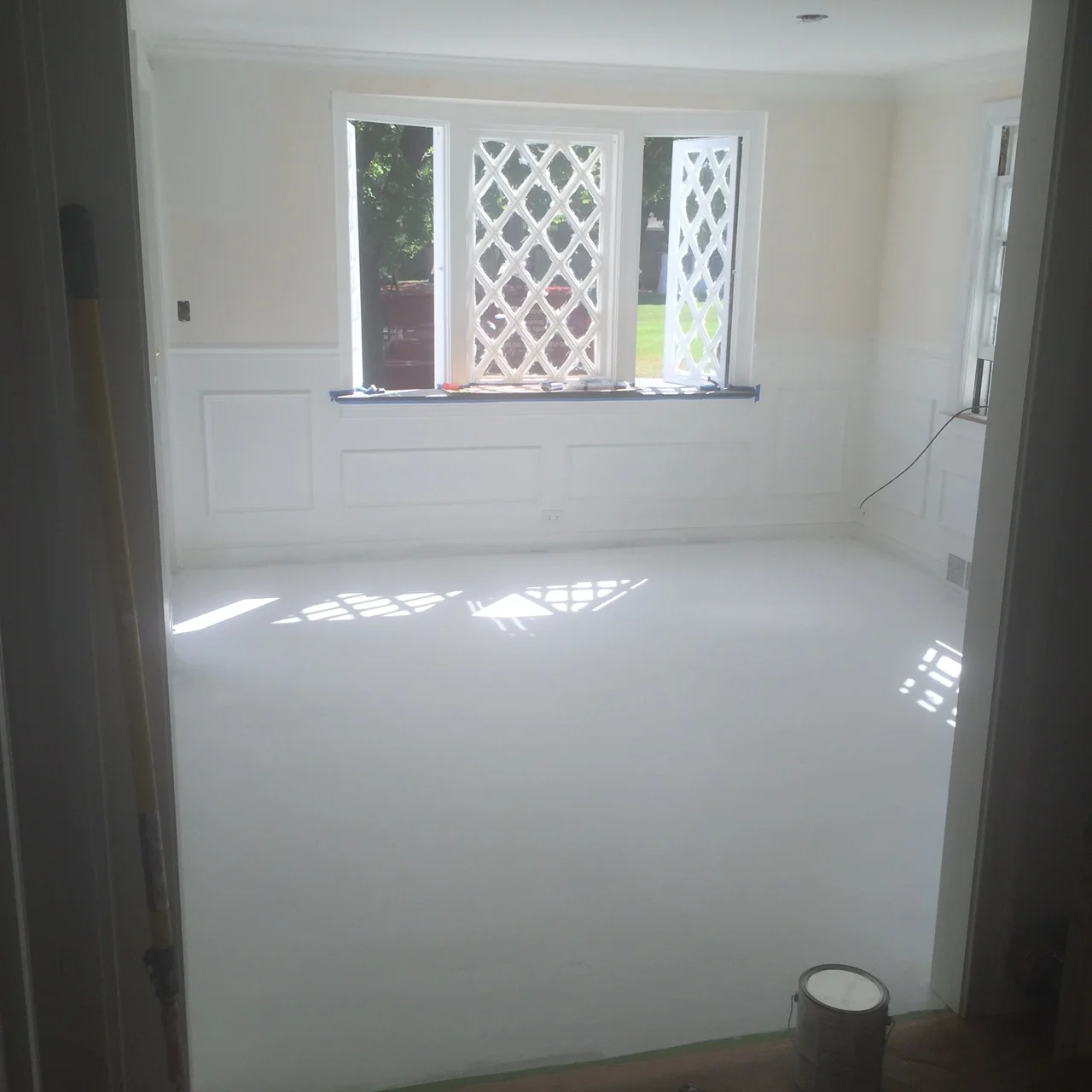 Time to start on my biggest and hottest (literally) project... the painted floor. Three coats of primer that definitely made me high. 