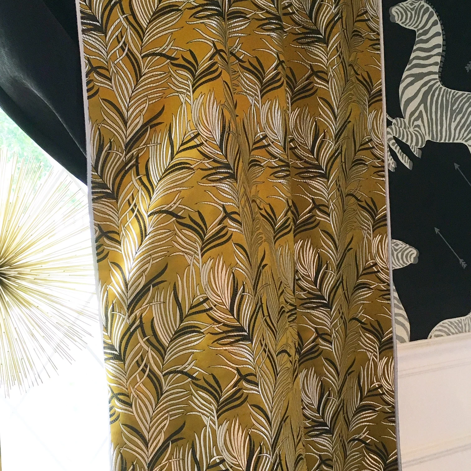 I loved the texture of the metal starburst, chartreuse brocade with metallic print curtains and the wallpaper with metallic finishes in the zebra's stripes. 