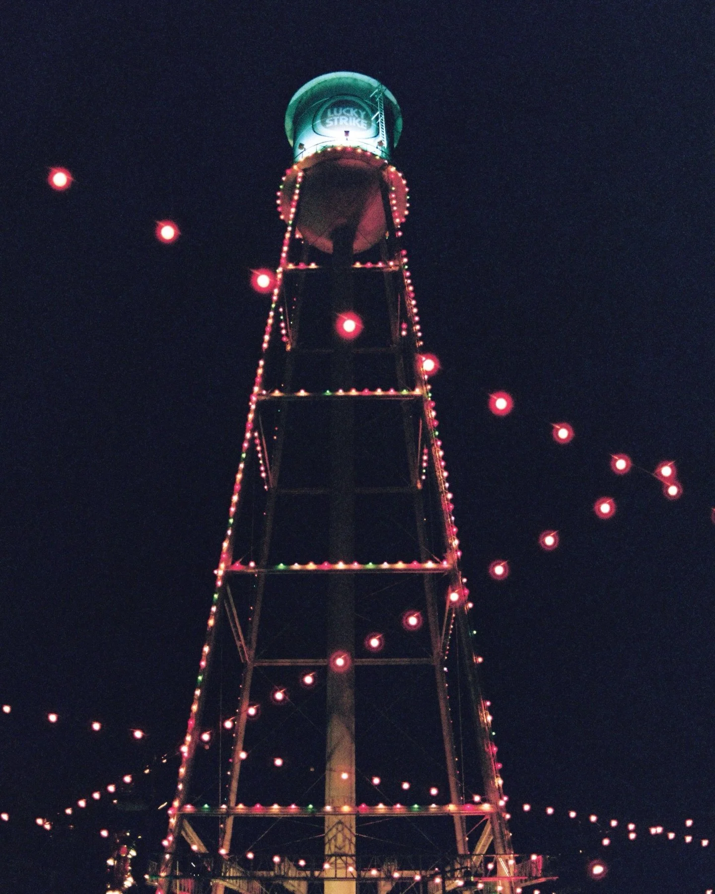 A festive water tower lighting on film. Merry Christmas &amp; Happy Holidays!!! 🎄

📸 Canon AE1 Program
🎞️ @cinestillfilm 400D 
🧑&zwj;🔬 @fotoshoppencc 
📍 @durhamnc Water Tower Lighting Ceremony 

&mdash;

#grainisgood #shootitwithfilm #filmisnot