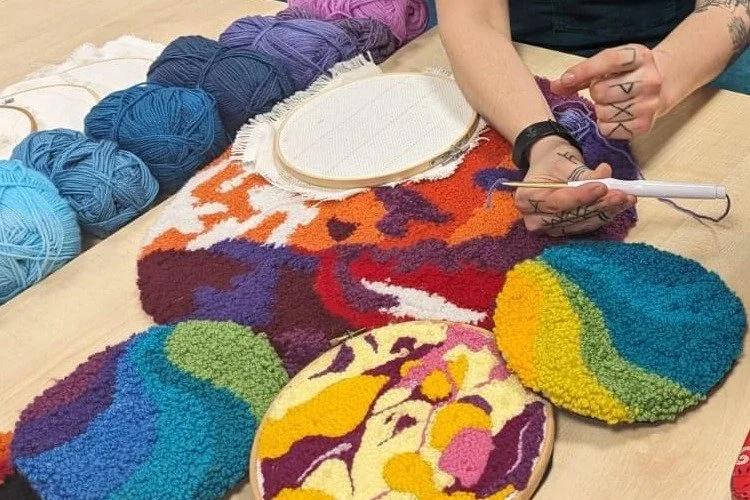 Rose's hands demonstrating punch needle beside bright colourful punch needle artworks