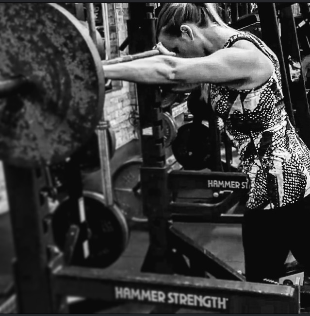 woman setting up for barbell back squat