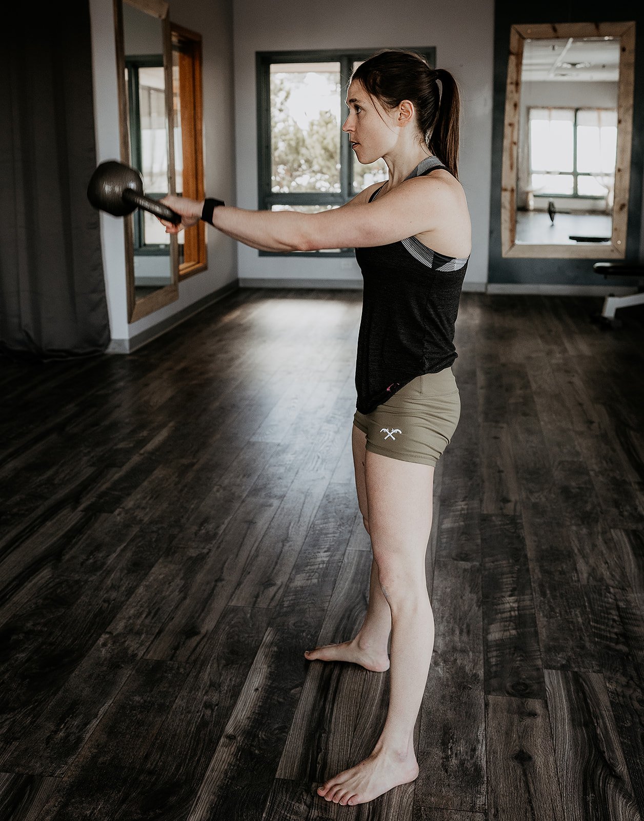 woman performing explosive training with a kettlebell swing