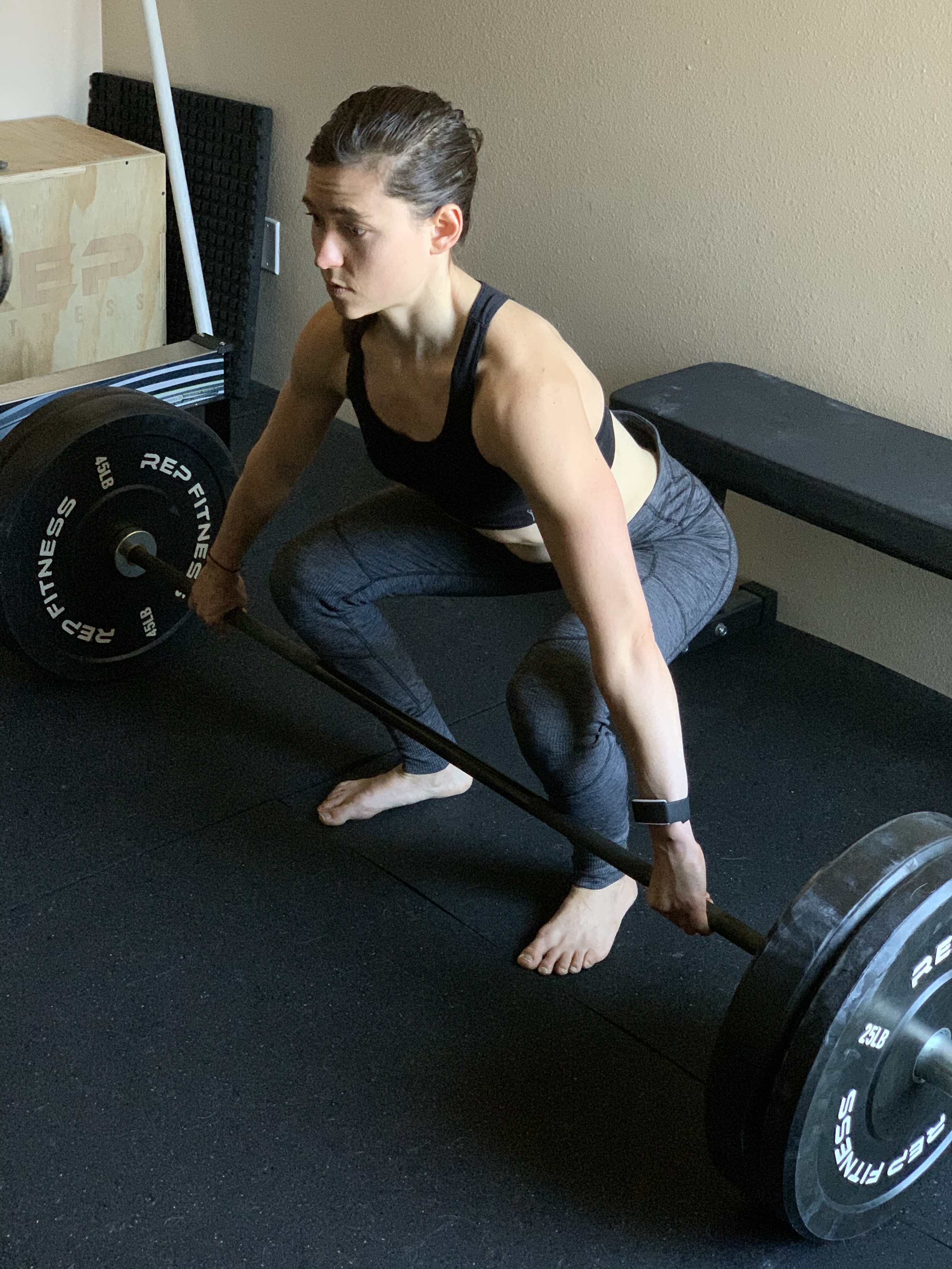 personal trainer performing snatch grip deadlift for lower body workout