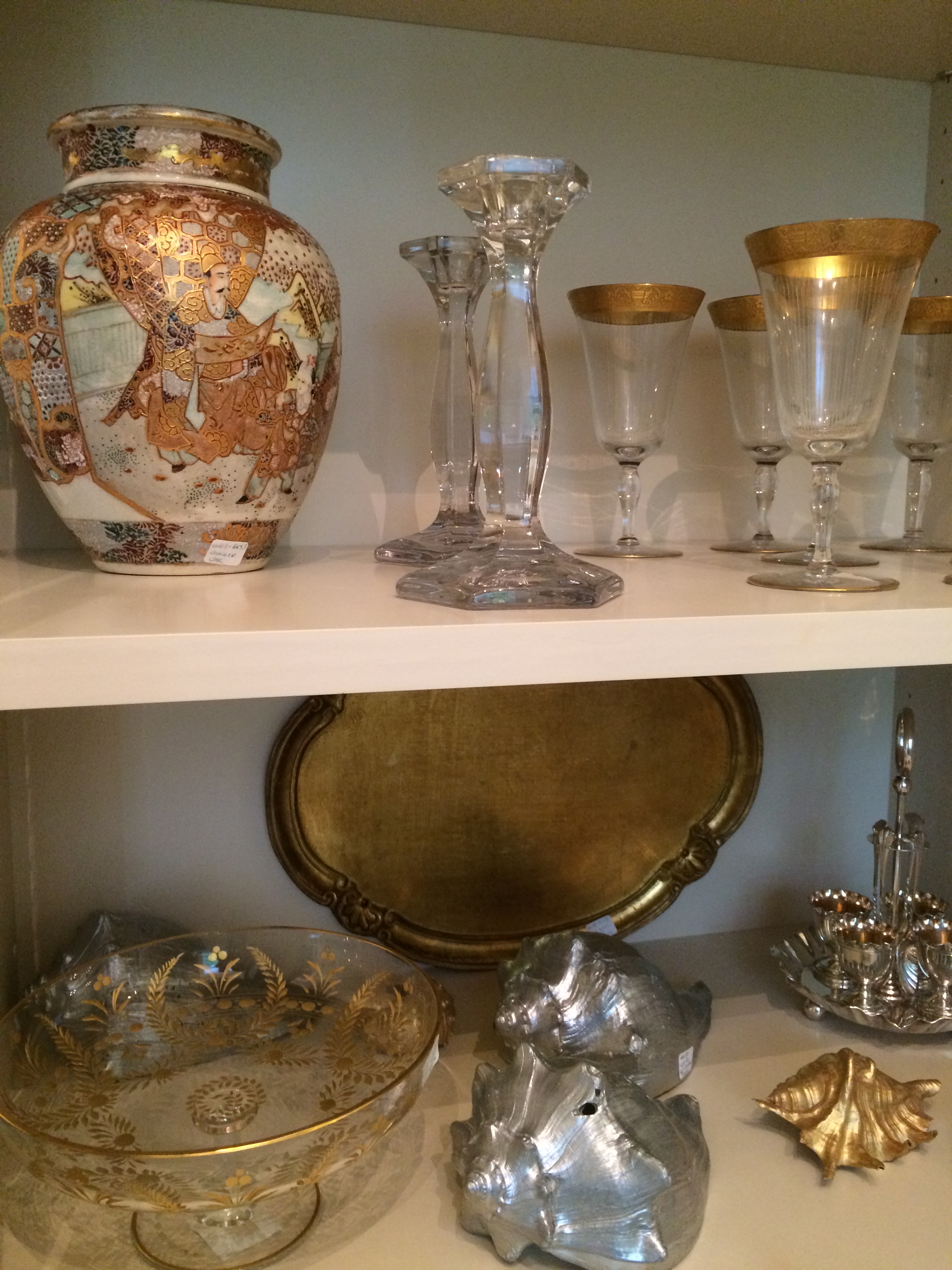 A ginger jar, candle sticks, gold rimmed stem ware, gilt trays and etc