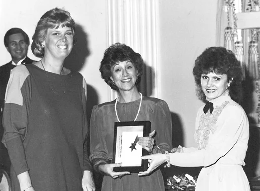 Left to right: Louise Tucker, Partner, and Founder Billie Jo Wanink accept award at first Haworth dealer meeting in 1981