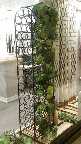 Here’s an easy, small scale way to incorporate greenery into your workspace. Faux greenery walls or focal points are a great, low-maintenance tool.