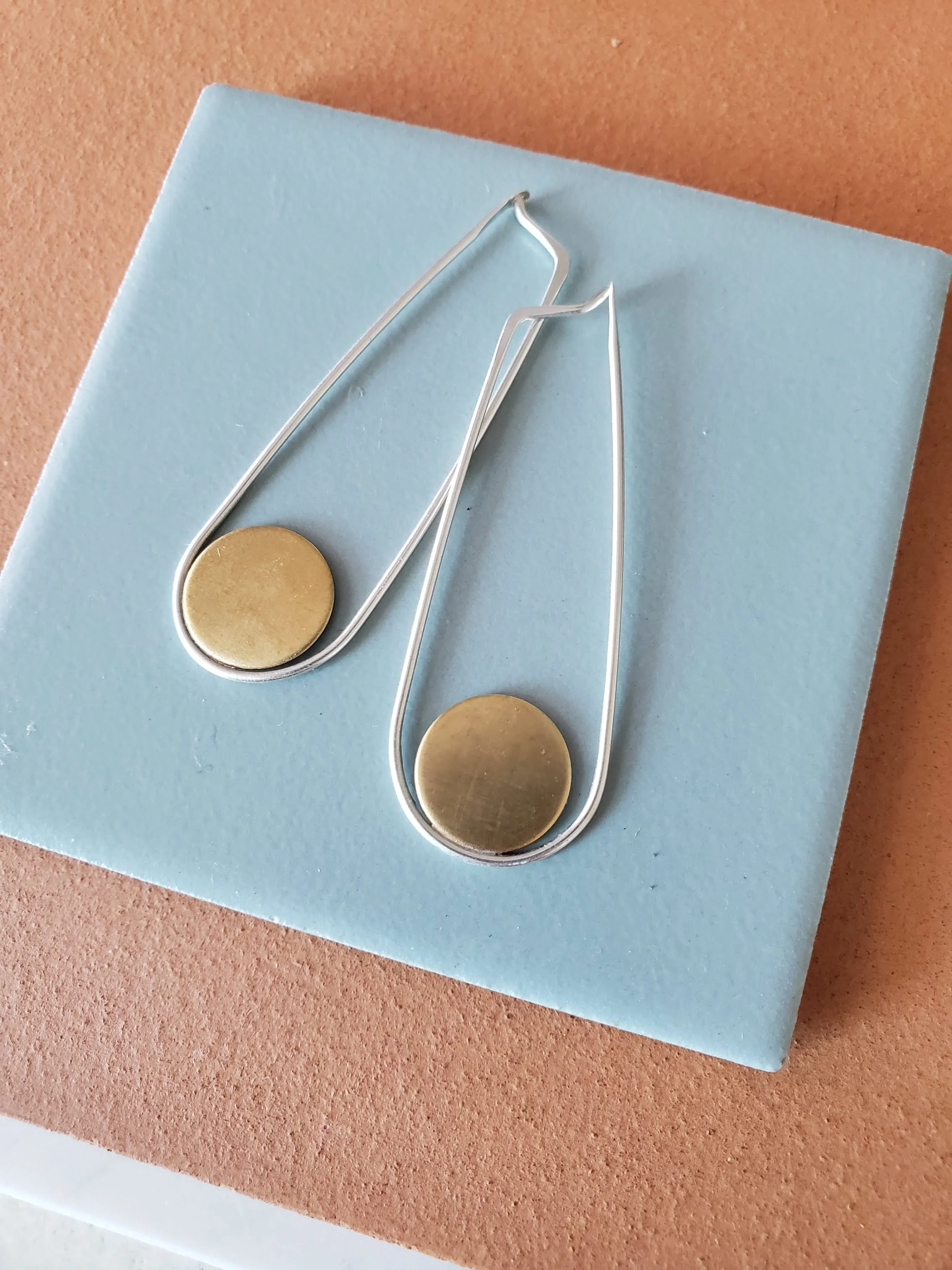 Long shiny brass and silver hoop earrings