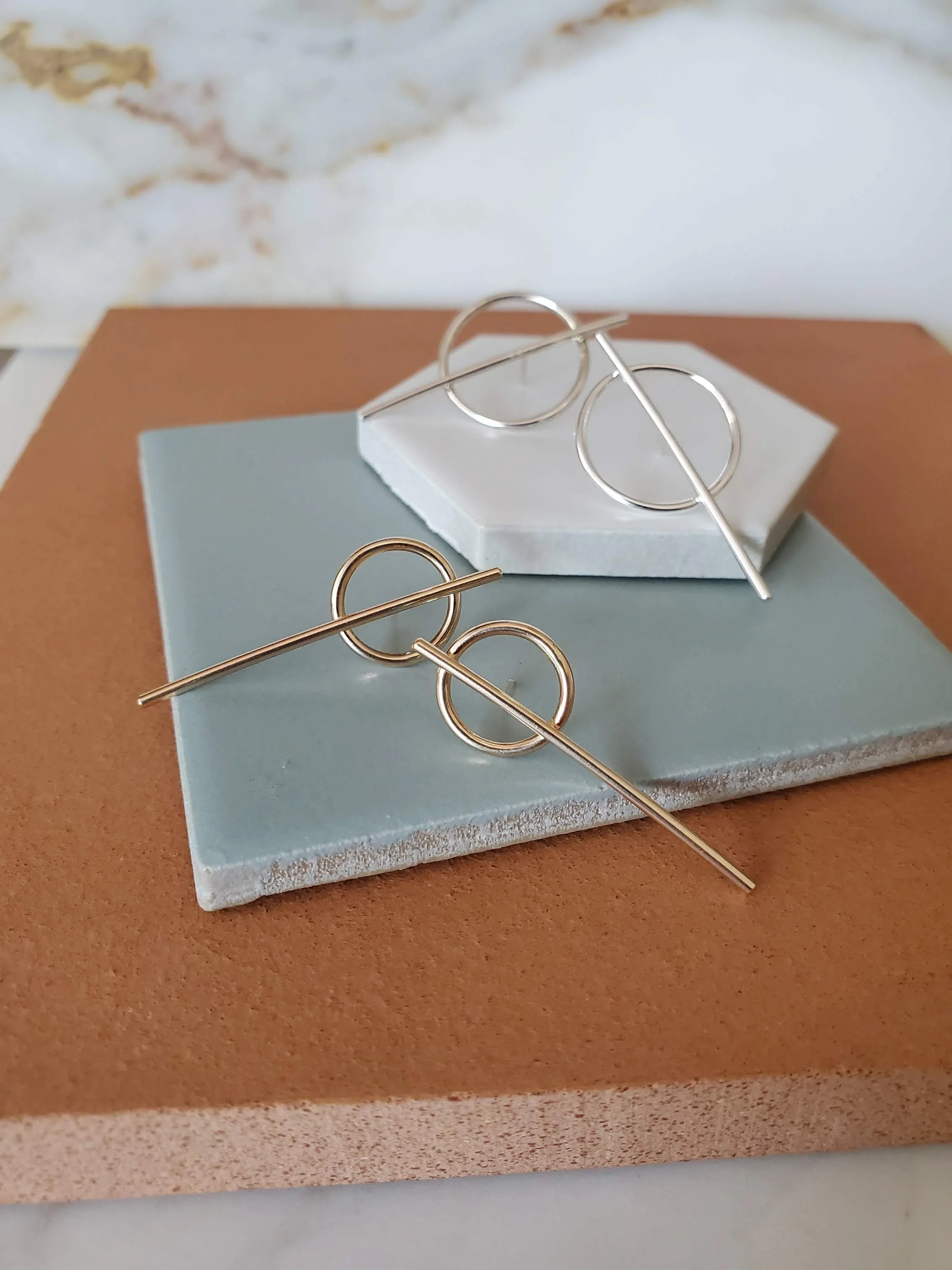 Geometric stud earrings in silver and gold