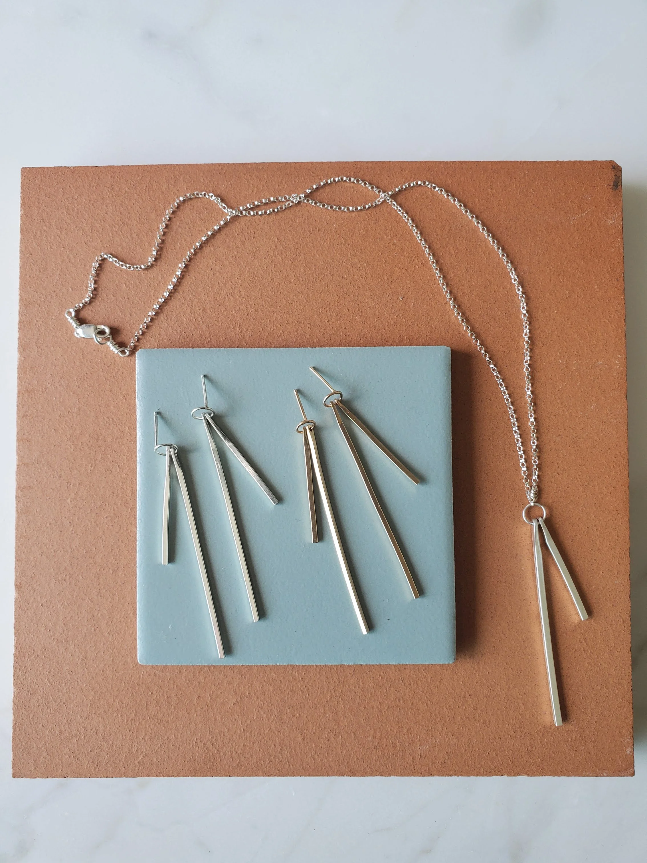 Silver silver and gold dangle geometric earrings
