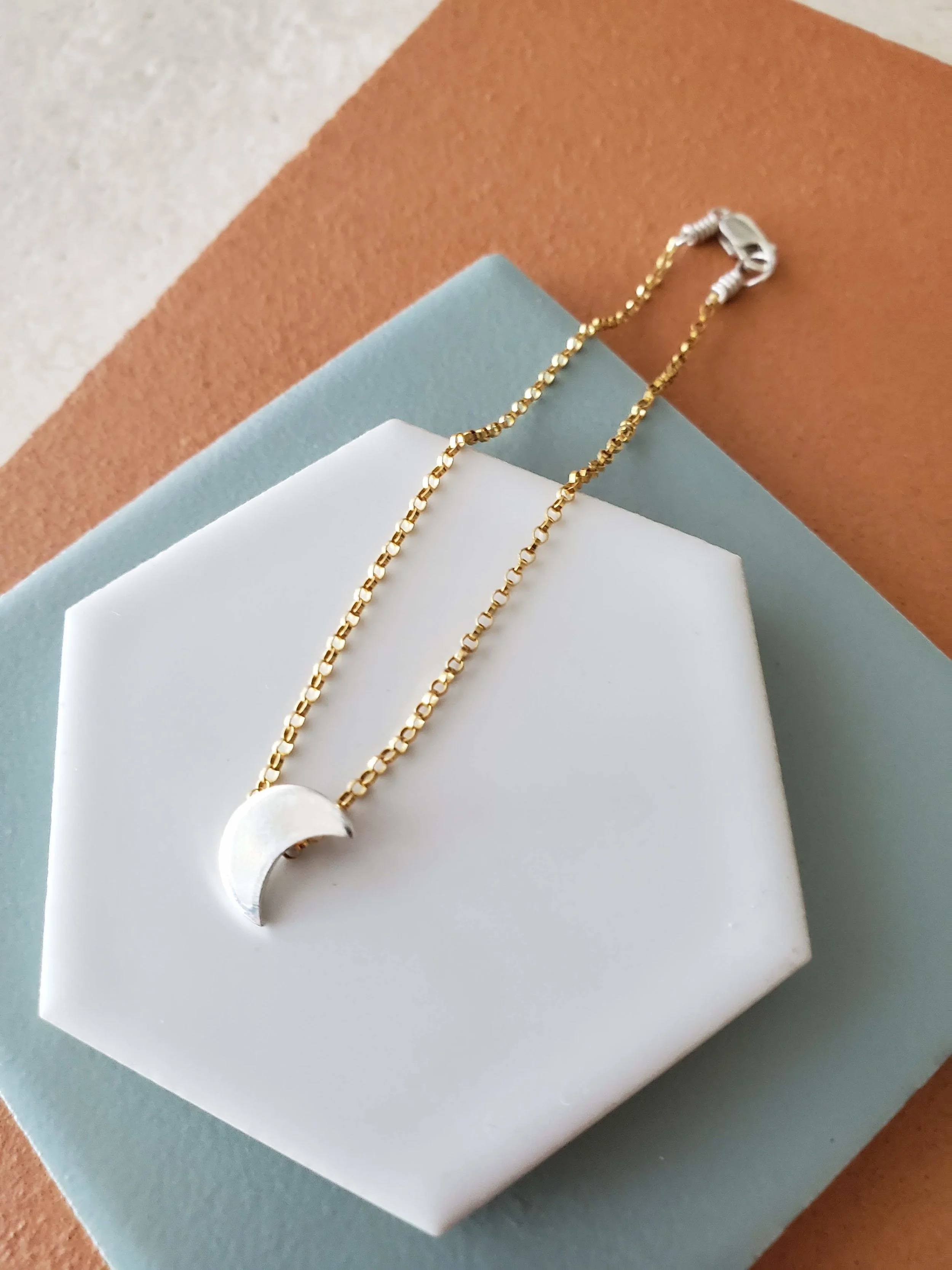 silver moon on gold chain in delicate geometric luna bracelet