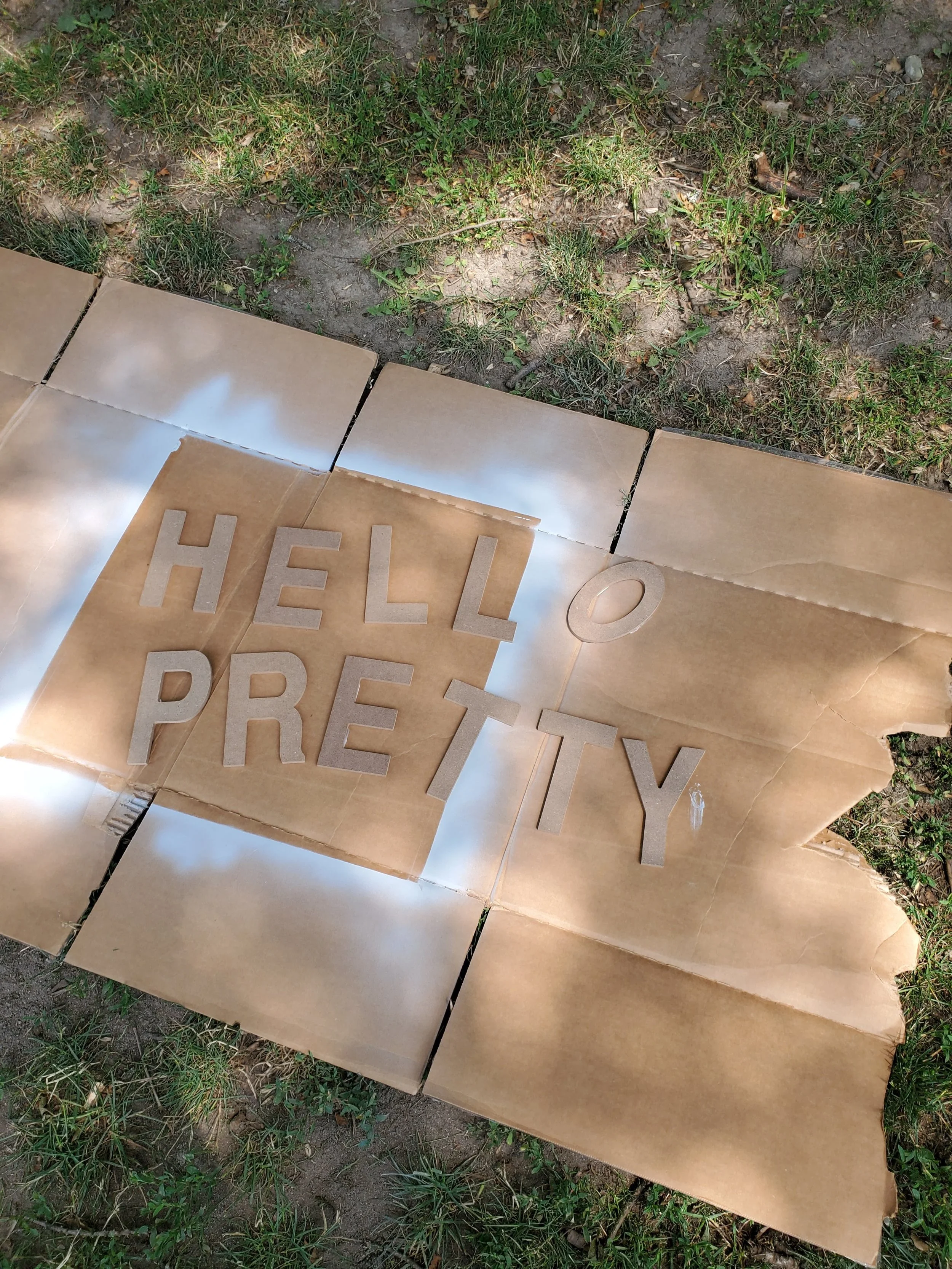 Sam took the letters, spray paint and some scrap cardboard to a local park where she spent the afternoon spraying the letters gold.