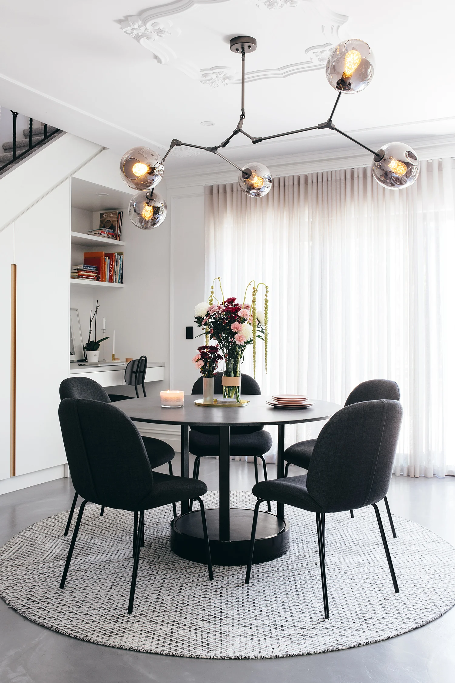 “It was a lot of work to add all the wainscoting, ceiling roses and plaster glass cornice throughout our home, but it produced a great result. To achieve a French-feeling interior, those kinds of details are required,” says Matt. Replica Lindsey Adelman ‘Bubble’ chandelier from Lucretia Lighting; ‘Bella’ dining chairs from GlobeWest; ‘Mila’ dining table from Nood Co.
