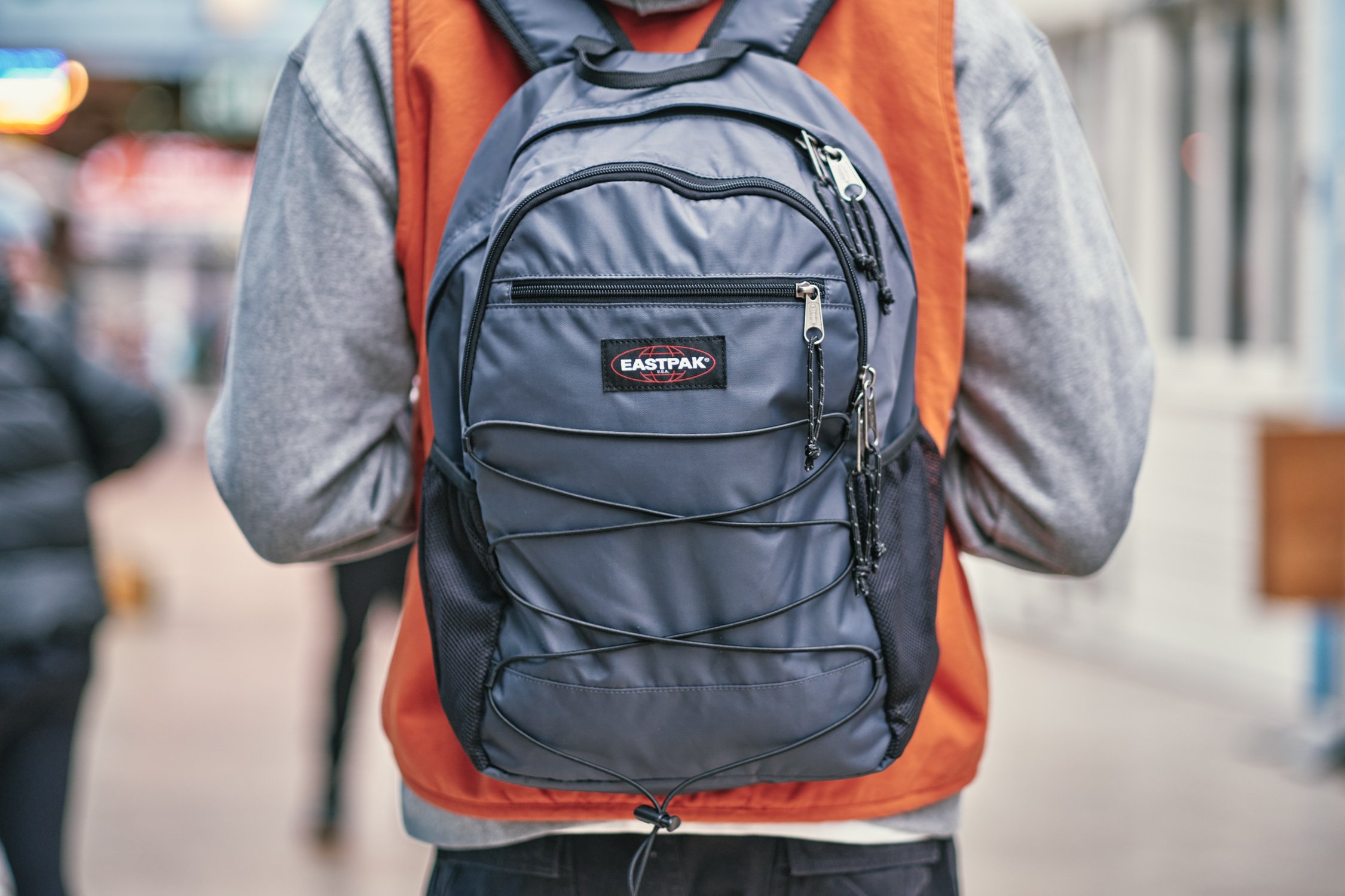Model carrying an Eastpak Quidel Powr backpack on location in London during a streetwear campaign shoot.