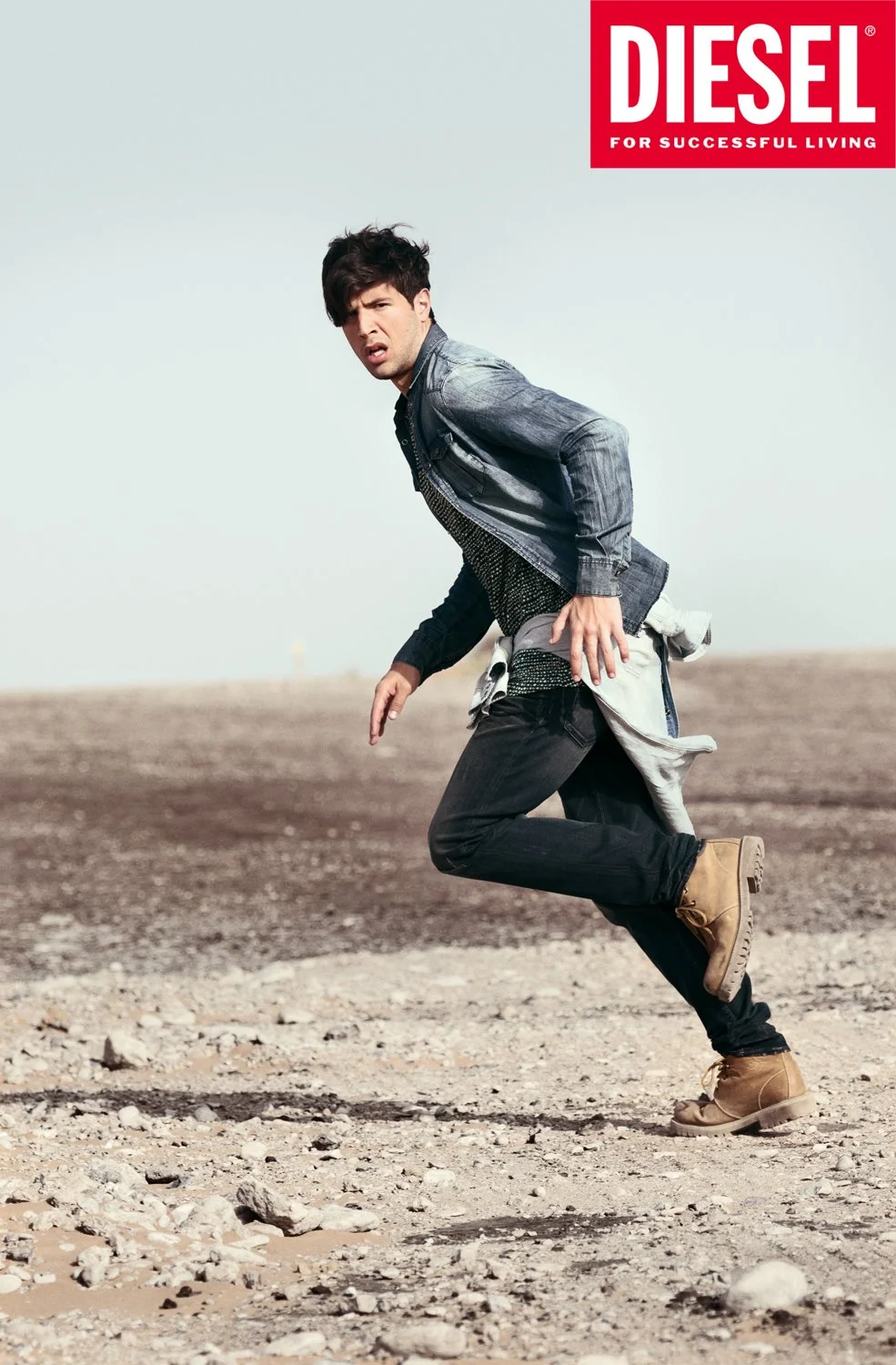Model running through the Dubai desert during an international fashion campaign for Diesel.