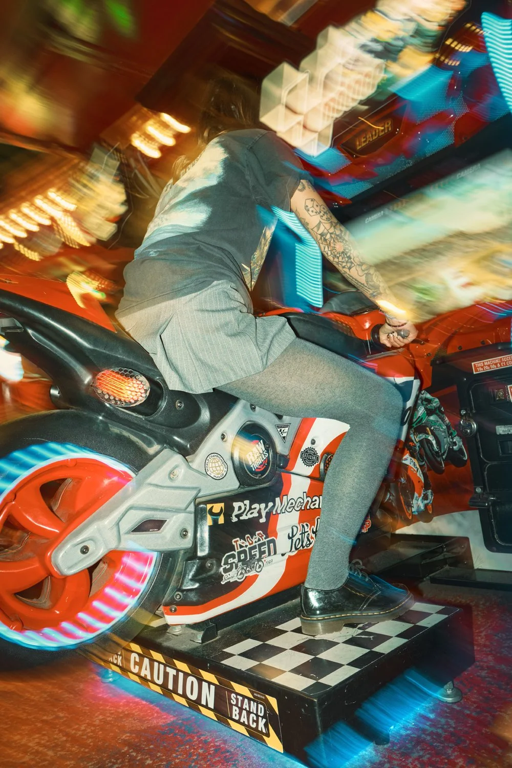 Creative Dr. Martens campaign photography inside a neon-lit arcade, combining movement, front flash and authentic youth culture storytelling for a commercial fashion campaign.