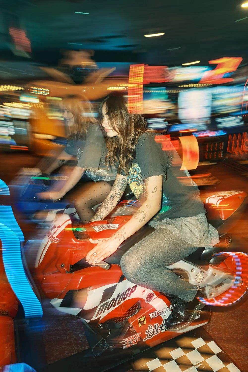 Creative Dr. Martens campaign photography inside a neon-lit arcade, combining movement, front flash and authentic youth culture storytelling for a commercial fashion campaign.