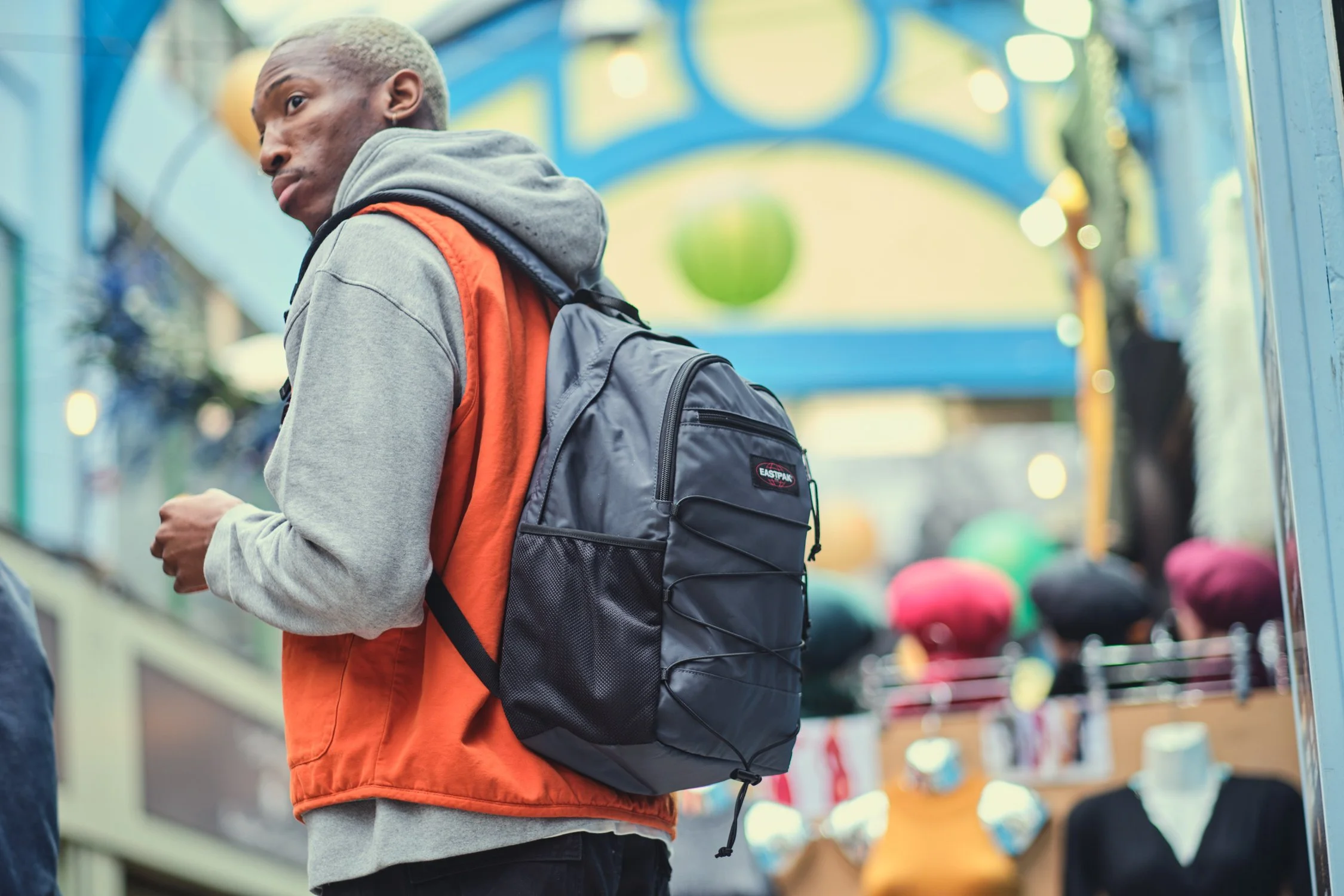 Model carrying an Eastpak Quidel Powr backpack on location in London during a streetwear campaign shoot.