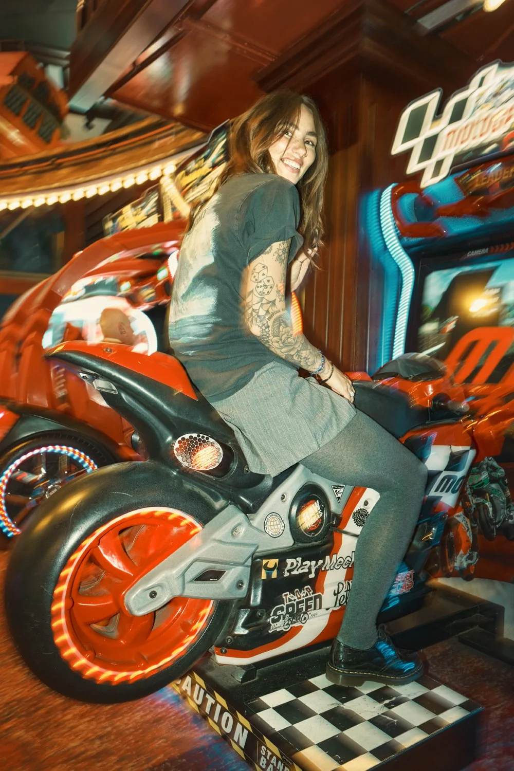Creative Dr. Martens campaign photography inside a neon-lit arcade, combining movement, front flash and authentic youth culture storytelling for a commercial fashion campaign.